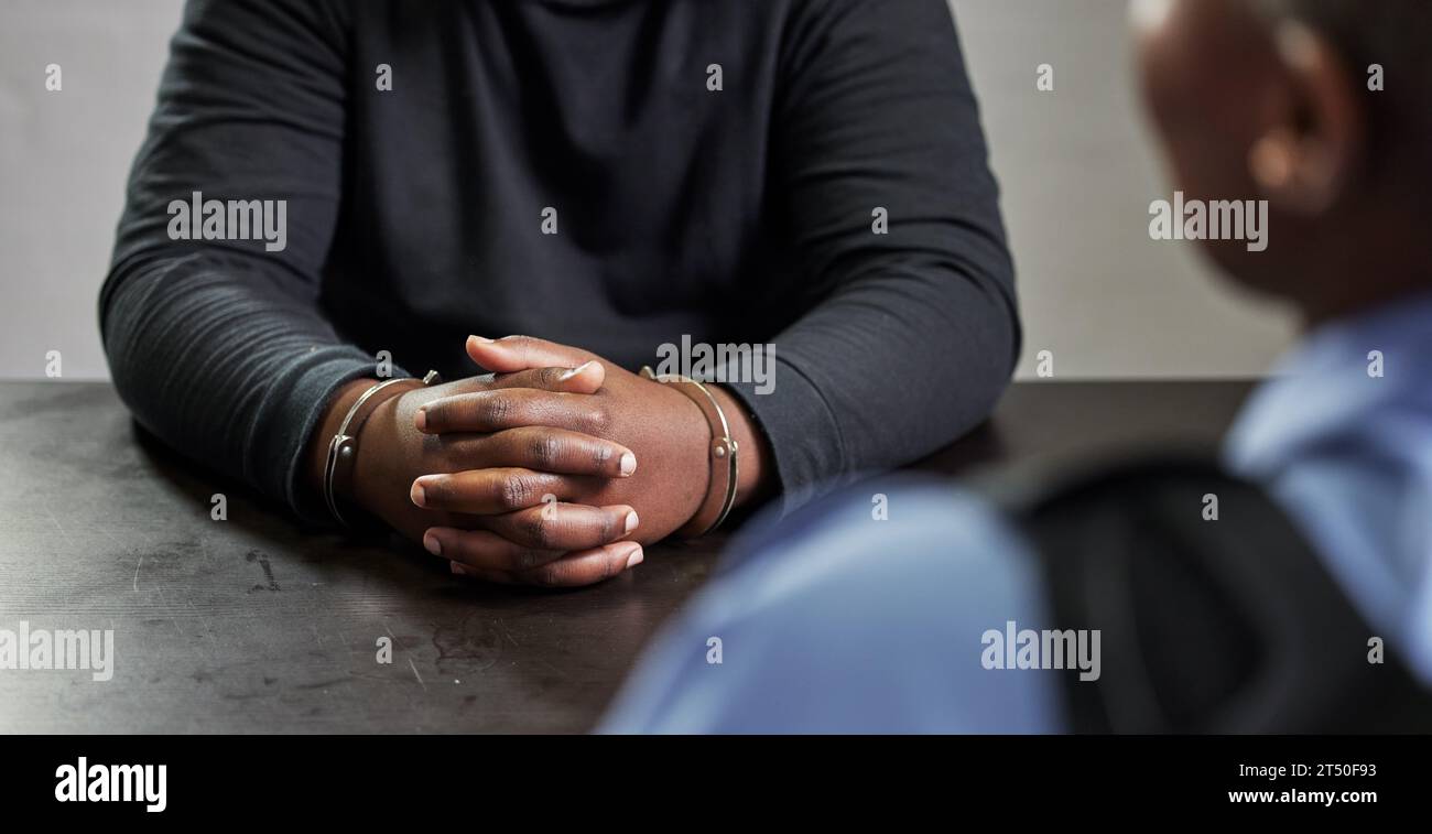 Criminal, hands and handcuffs and table for interrogation, questions or