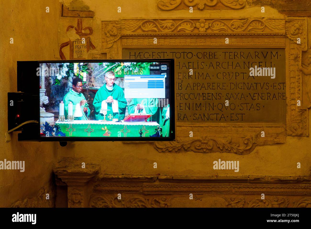 Television showing the Mass outside the Grotto of the Sanctuary of Saint Michael the Archangel