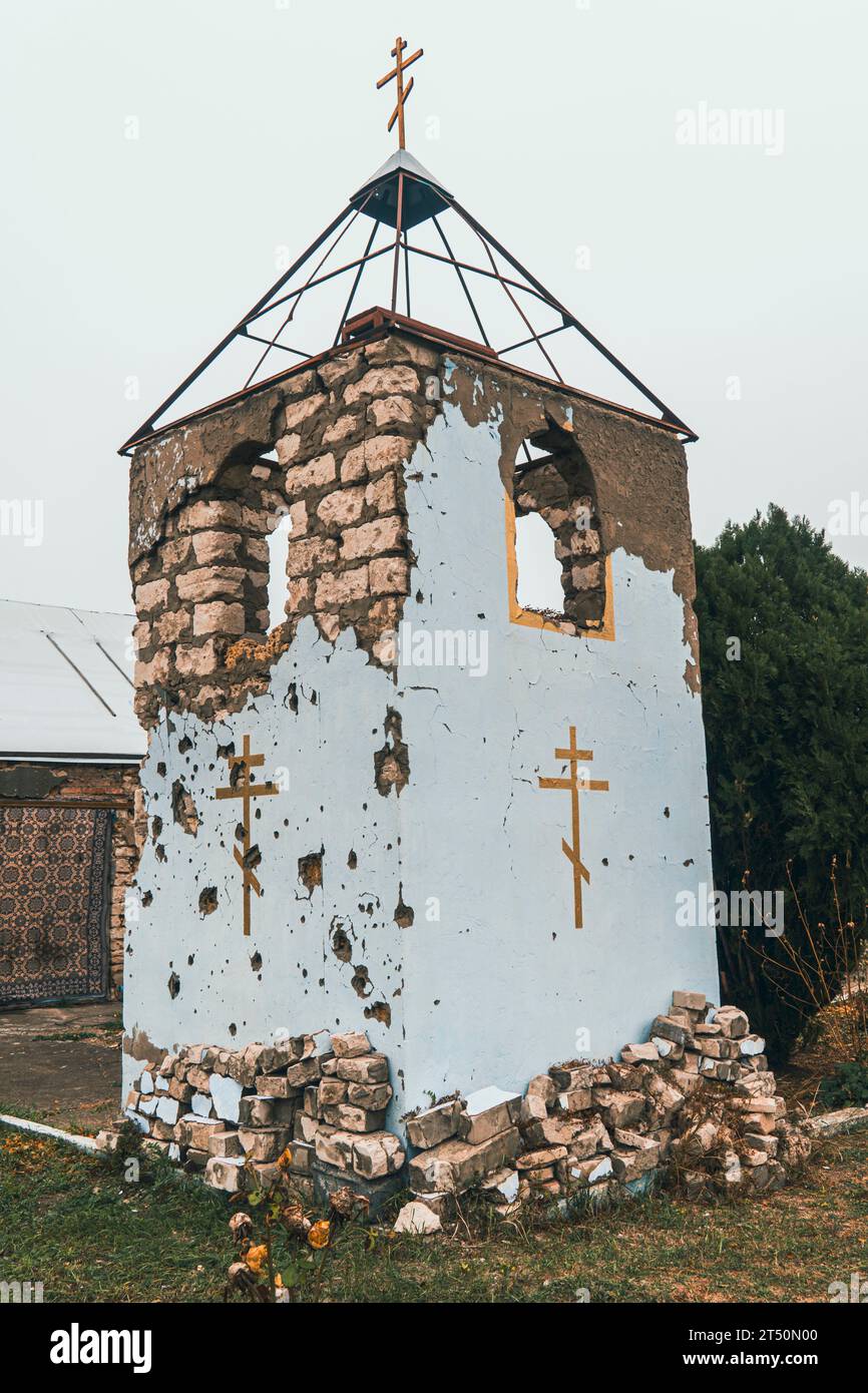 Countryside. The tower of the Orthodox Church damaged by shelling. War in Ukraine. Russian invasion of Ukraine. Terror of civilians Stock Photo