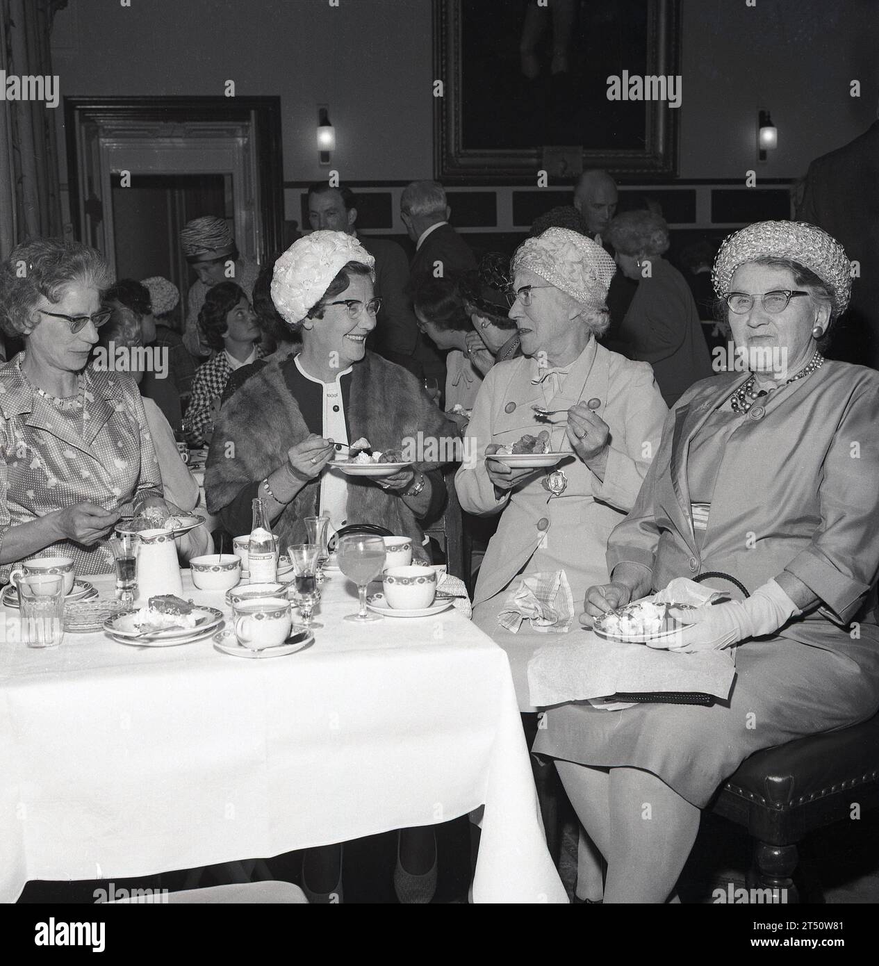 1960s, historical, four welldressed elderly ladies at a function