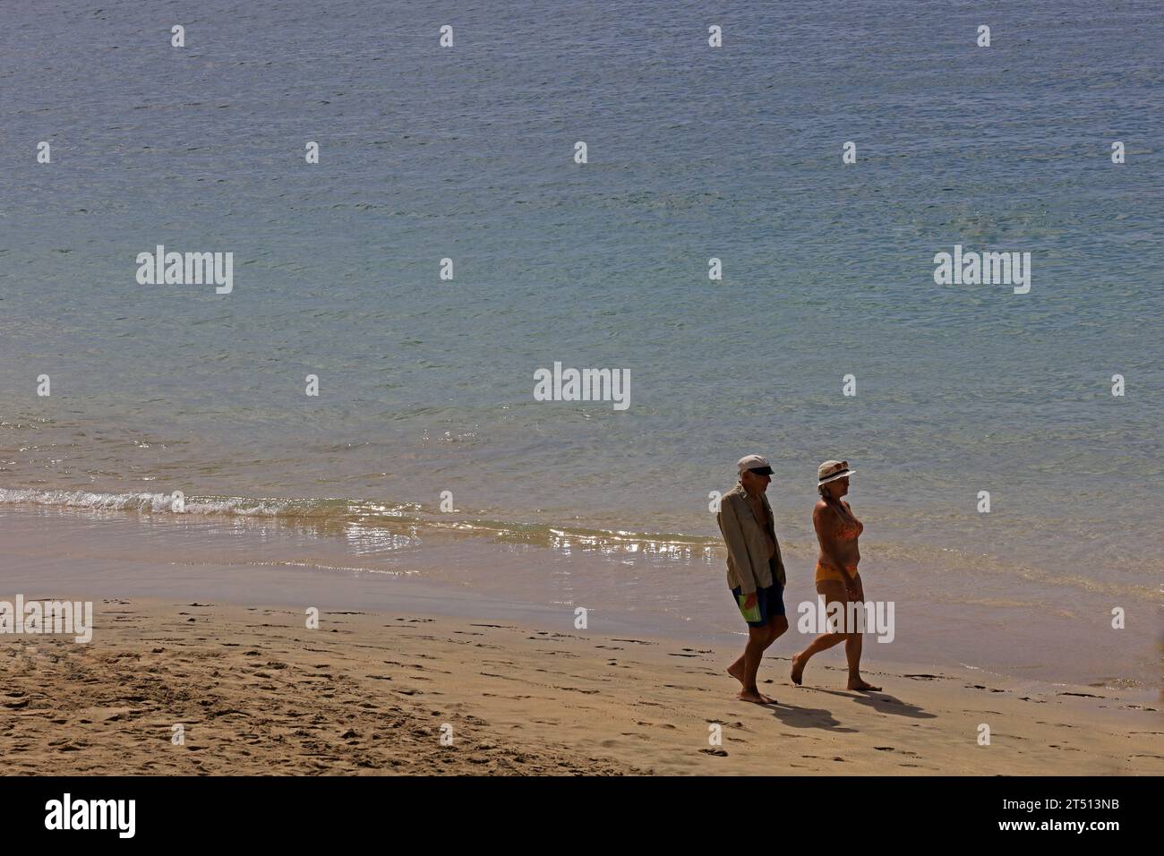 Couple enjoying Playa Dorada beach, Lanzarote. Taken March 2023 Stock Photo