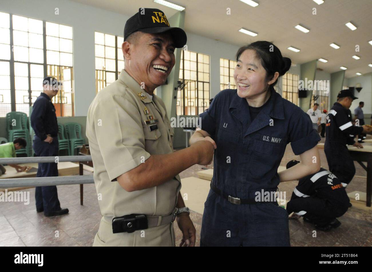 110215-N-9094S-076  MANILA, Philippines (Feb. 15, 2011) Machinist's Mate Fireman Man Li shakes hands with Republic of the Philippines navy Chief Petty Officer Pablo Bauit during a U.S. 7th Fleet command ship USS Blue Ridge (LCC 19) community service activity at the Hospicio De San Jose. U.S. Navy personnel have volunteered at the Hospicio De San Jose for more than 100 years. Blue Ridge serves under Commander, Expeditionary Strike Group (ESG) 7/Task Force (CTF) 76, the Navy's only forward deployed amphibious force. (U.S. Navy photo by Mass Communication Specialist 3rd Class Brian A. Stone/Relea Stock Photo