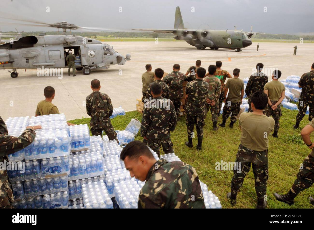0806265961C-011  KALIBO, Philippines (June 26, 2008) Servicemen of the Philippine Army stage themselves to transport bottled water to aircrafts assigned to the U.S. Navy and the Republic of the Philippines Air Force. The U.S. Navy and the Philippine Army and Air Force have been working side by side during disaster relief in the wake of Typhoon Fengshen. At the request of the government of the Republic of the Philippines, the Nimitz-class aircraft carrier USS Ronald Reagan (CVN 76) is off the coast of Panay Island providing humanitarian assistance and disaster response. Ronald Reagan and other Stock Photo