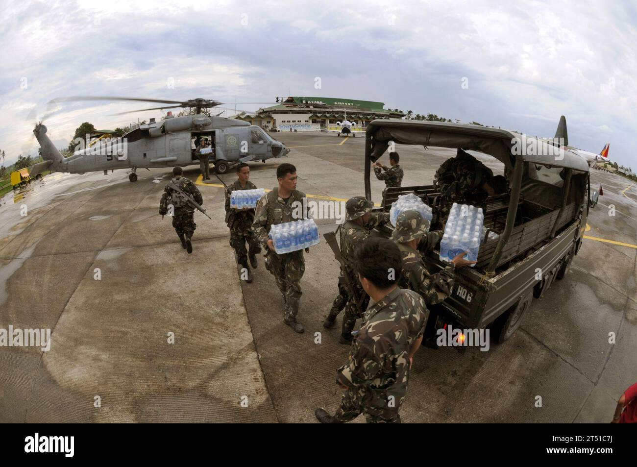 0806265961C-008  KALIBO, Philippines (June 26, 2008) Servicemen from the United States Navy and the Philippine Army work together unloading much needed supplies for people suffering in the wake of Typhoon Fengshen at Kalibo Airport. At the request of the government of the Republic of the Philippines, the Nimitz-class aircraft carrier USS Ronald Reagan (CVN 76) is off the coast of Panay Island providing humanitarian assistance and disaster response. Ronald Reagan and other U.S. Navy ships are operating in the 7th Fleet area of responsibility to promote peace, cooperation and stability. U.S. Nav Stock Photo