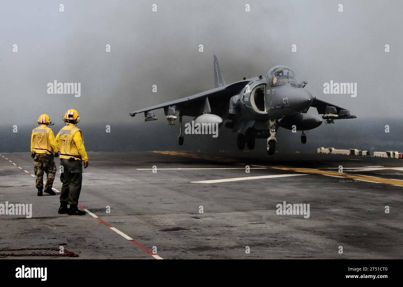 1104117508R-002 ATLANTIC OCEAN (April 11, 2011) Landing signal enlisted (LSE) personnel observe as  AV-8B Harrier assigned to Marine Medium Tiltrotor Squadron (VMM) 263 (Reinforced) land aboard the multipurpose amphibious assault ship USS Bataan (LHD 5). Bataan is deploying to the Mediterranean Sea. Navy Stock Photo