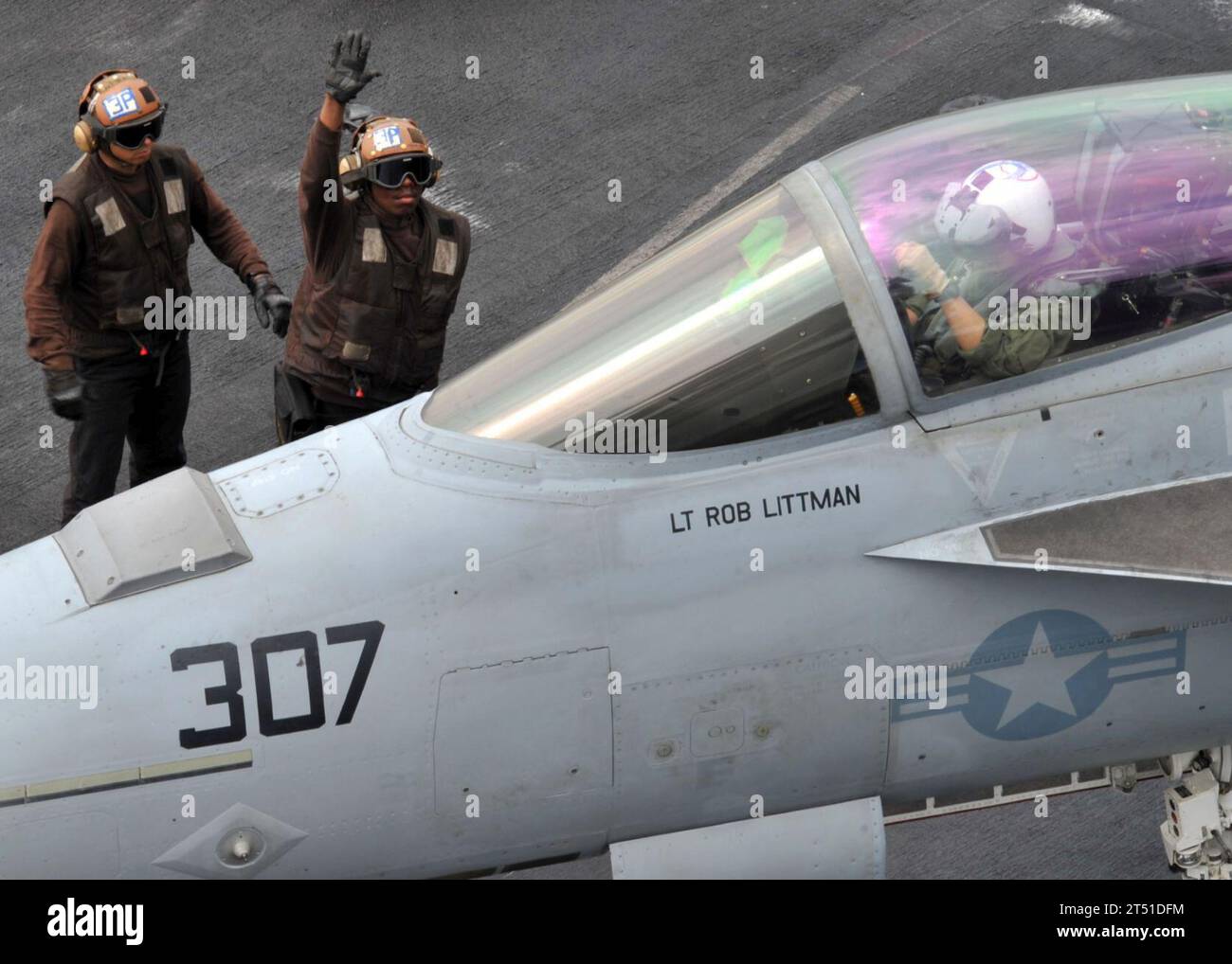 1103070569K-020 RED SEA (March 7, 2011) A plane captain signals to a pilot assigned to the Knighthawks of Strike Fighter Squadron (VFA) 136 before a cycle of flight operations aboard the aircraft carrier USS Enterprise (CVN 65). Enterprise and Carrier Air Wing (CVW) 1 are on a routine deployment conducting maritime security operations in the U.S. 5th Fleet area of responsibility. Navy Stock Photo