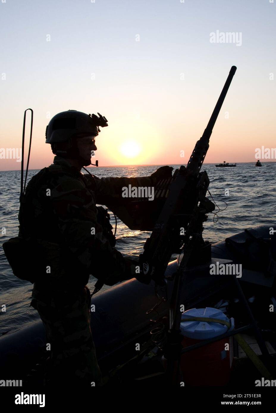 0809034500G-416 PINEY ISLAND, N.C. (Sept. 3, 2008) A Special Warfare Combatant-craft Crewman (SWCC) from Special Boat Team 20 holds a .50-caliber machine gun steady in between live-fire drills on the Pamlico Sound. Several Naval Special Warfare 11-meter rigid-hull inflatable boat detachments participated in the training, which included training on grenade launchers and .50-caliber machine guns preparing for an upcoming deployment supporting the Global War on Terror. Navy Stock Photo