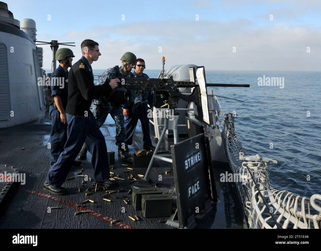 110511NL541-303 ATLANTIC OCEAN (May 11, 2011) Cmdr. Jeffrey Scudder, commanding officer of the guided-missile frigate USS Thach (FFG 43), fires a .50-caliber machine gun during a pre-action calibration fire. Thach is deployed supporting Southern Seas 2011. Navy Stock Photo