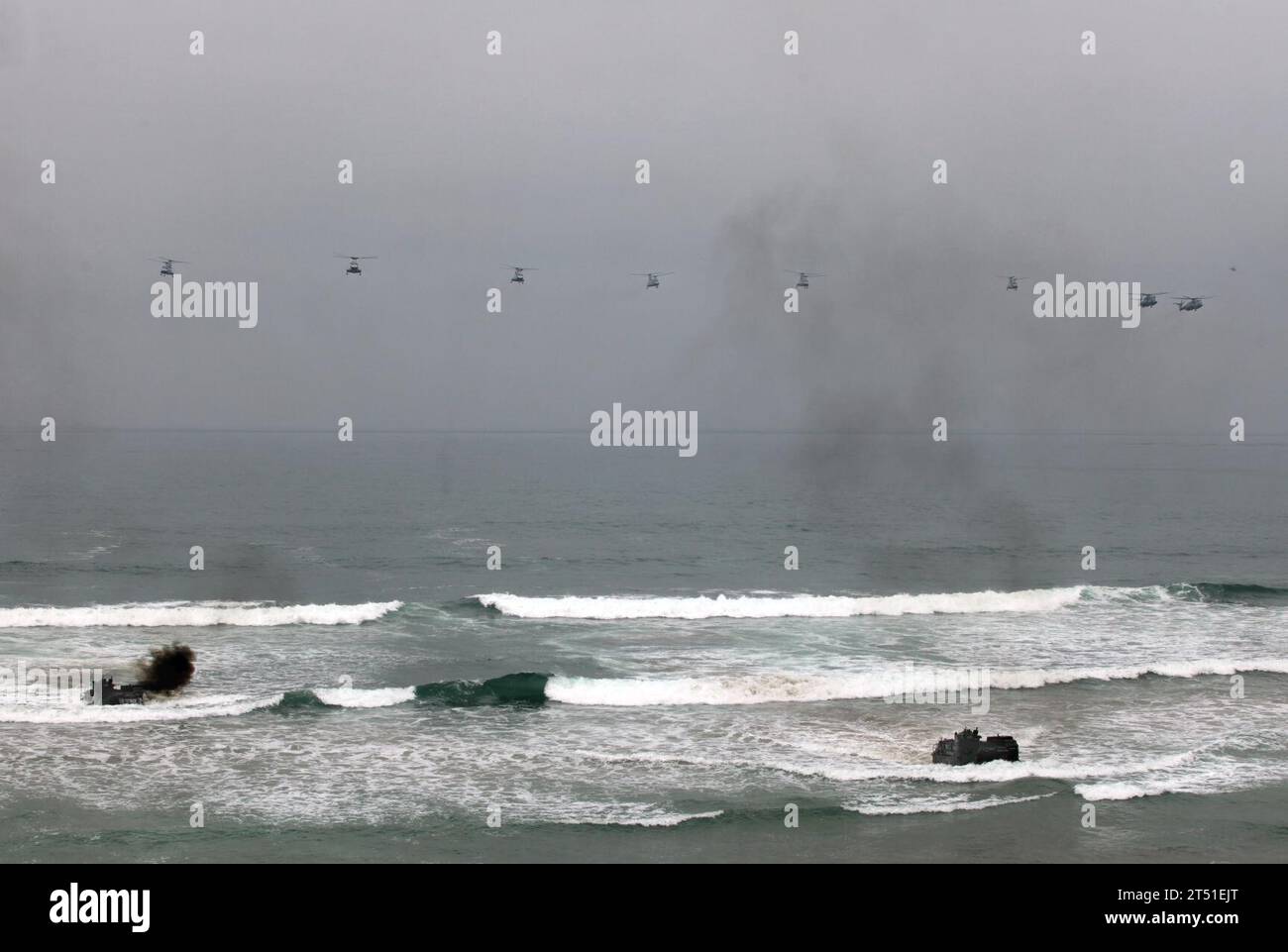 1006047404B-002 CAMP PENDLETON, Calif. (June 4, 2010) Amphibious assault vehicles transporting Marines from the 1st Battalion, 7th Marines land at Red Beach at Camp Pendleton as helicopters from Marine Heavy Helicopter Squadron (HMH) 465 fly overhead during exercise Dawn Blitz. The exercise is a series of amphibious operations involving Sailors and Marines to reinvigorate the core competency of amphibious operations and enhance interaction between the Navy and the Marine Corps. (U.S. Marine Corps Stock Photo