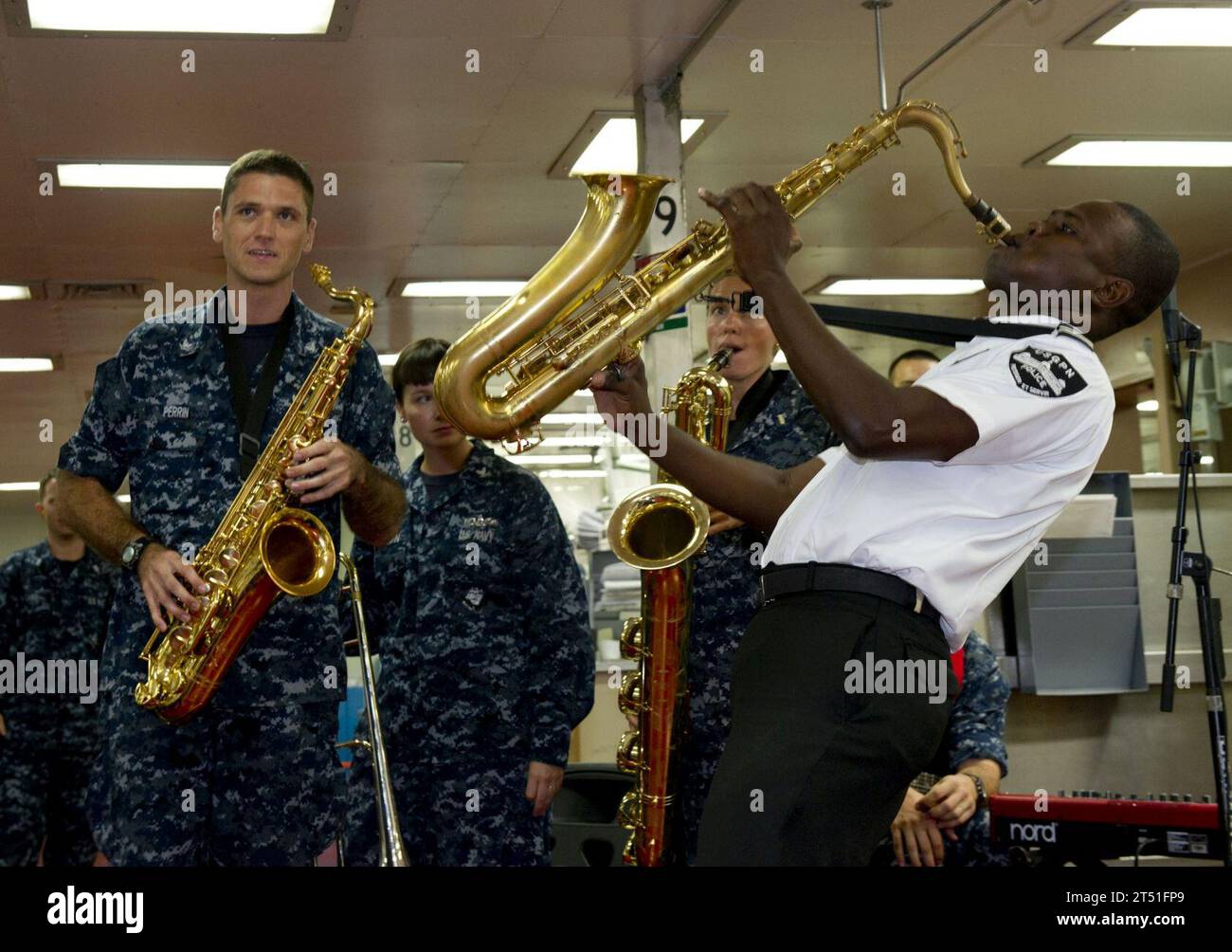 110829RM525-138 PORT-AU-PRINCE, Haiti (Aug. 29, 2011) A Haitian Police Band member plays the saxophone with U.S. Fleet Forces Band aboard the Military Sealift Command hospital ship USNS Comfort (T-AH 20) during Continuing Promise 2011. Continuing Promise is a five-month humanitarian assistance mission to the Caribbean, Central and South America. Navy Stock Photo