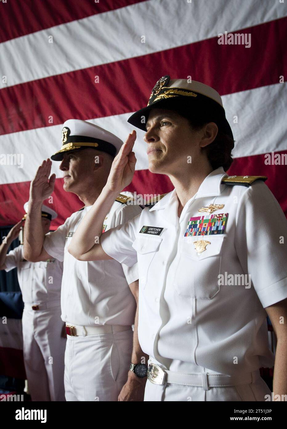 110622KK576-099 VIRGINIA BEACH, Va. (June 22, 2011) Rear Adm. Gretchen S. Herbert salutes with the official party as her flag is hauled up during a change of command ceremony at Joint Expeditionary Base Little Creek-Fort Story. Herbert relieved Rear Adm. Tom P. Meek as commander of Navy Cyber Forces. Navy Stock Photo