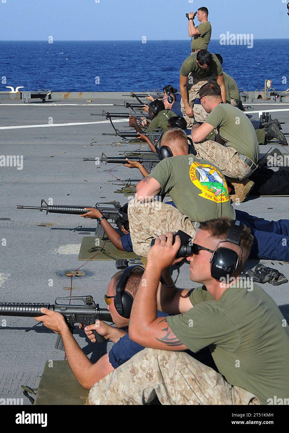 1005041082Z-032 U.S 5TH FLEET AREA OF RESPONSIBILITY (May 4, 2010) Marines assigned to the 24th Marine Expeditionary Unit (24th MEU) watch the downrange targets during an M16 service rifle live-fire training exercise for Sailors aboard the amphibious dock landing ship USS Ashland (LSD 48). Ashland is part of the Nassau Amphibious Ready Group and is supporting maritime security operations and theater security cooperation operations in the U.S. 5th Fleet area of responsibility. Navy Stock Photo