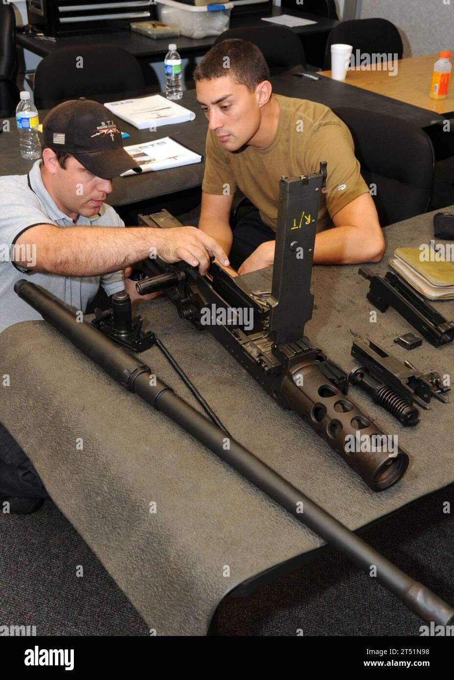 0907282651J-025 NORFOLK (July 28, 2009) A U.S. Navy special warfare combatant-craft crewman assigned to Special Boat Team (SBT) 20 is instructed on the components of a .50-caliber machine gun during a weapon operation and maintenance class. Members of SBT-20 are familiarizing themselves with weapons use and maintenance. Navy Stock Photo
