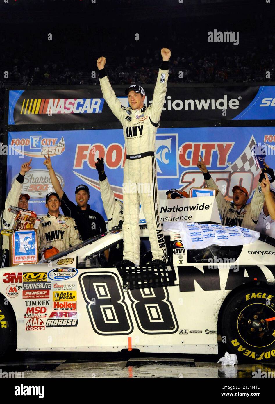 0808225345W-213 BRISTOL, Tenn. (Aug. 22, 2008) JR Motorsports driver Brad Keselowski celebrates on top of the No. 88 U.S. Navy Chevrolet Monte Carlo along with his crew in victory lane after winning the NASCAR Nationwide Series Food City 250 at Bristol Motor Speedway in Bristol. Keselowski overcame a 37th place starting position to claim his second career victory and won second place overall in the nationwide championship standings. Navy Stock Photo