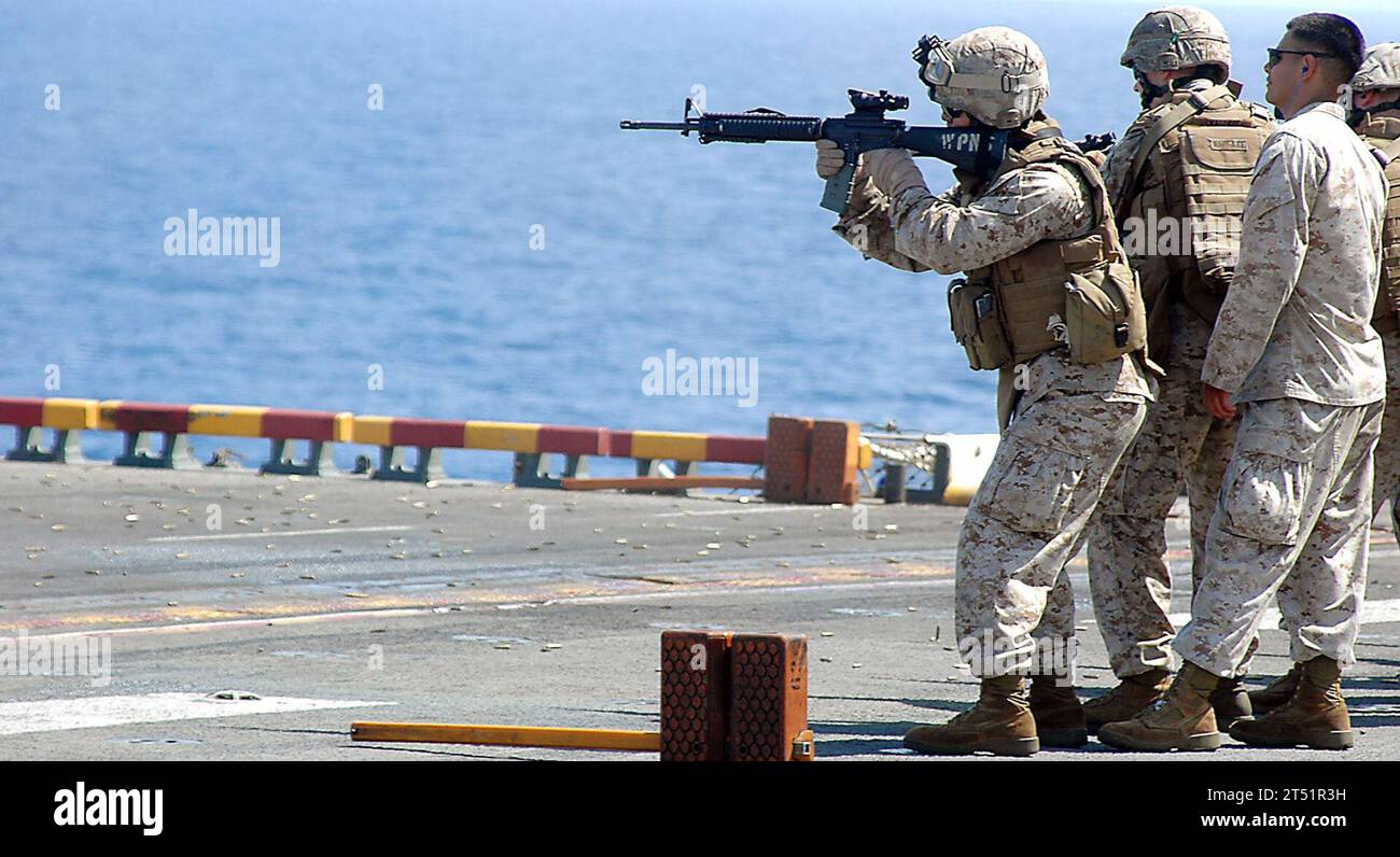 0905106410J-037 INDIAN OCEAN (May 10, 2009) Marines assigned to the 13th Marine Expeditionary Unit (13th MEU) embarked aboard the amphibious assault ship USS Boxer (LHD 4) fire at targets during small arms weapons training on the shipХs flight deck. Boxer is deployed as part of Boxer Amphibious Readiness Group/13th MEU supporting maritime security operations in the U.S. 5th Fleet area of Responsibility. Navy Stock Photo