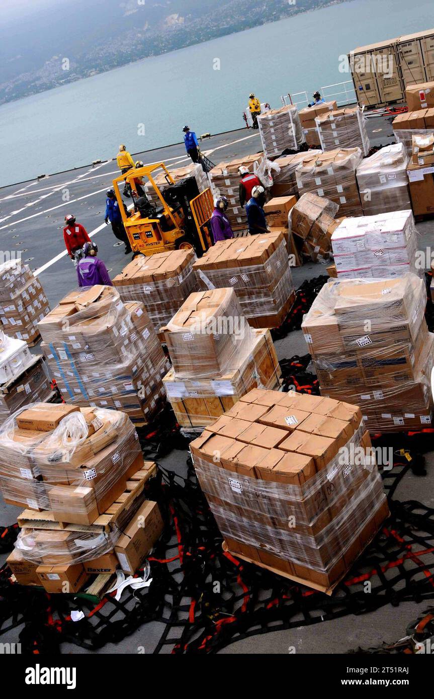1003016410J-242 CARIBBEAN SEA (March 1, 2010) Sailors aboard USNS Comfort (T-AH 20) work together to safely store supplies received from the Military Sealift Command supply ship USNS Sacagawea (T-AKE 2).  The supplies will allow Comfort to sustain efforts in support of Operation Unified Response.  Navy Stock Photo