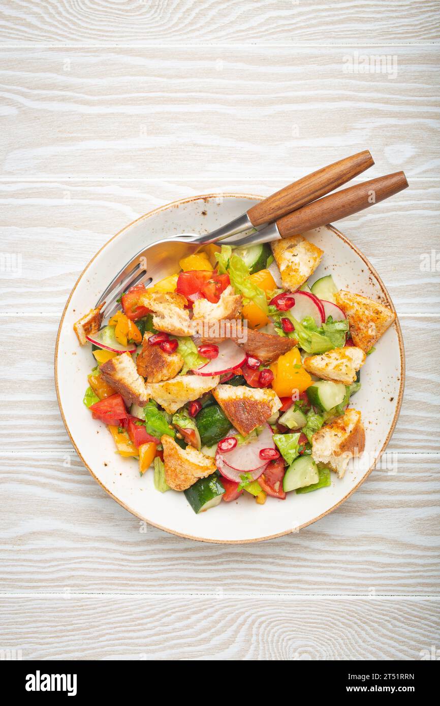 Traditional Levant dish Fattoush salad, Arab cuisine, with pita bread croutons, vegetables