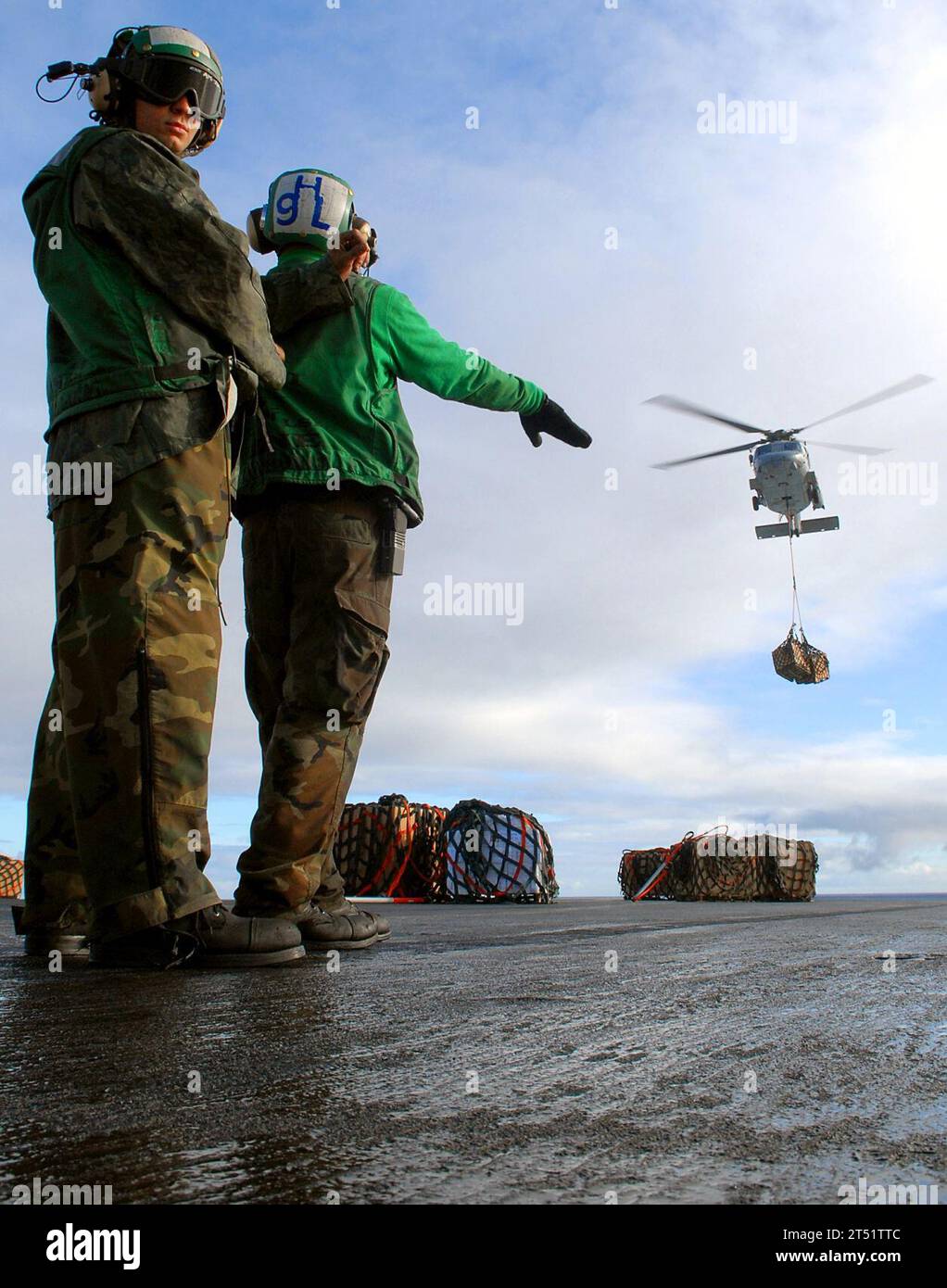 0712088132M-064 ATLANTIC OCEAN (Dec. 8, 2007) Sailors aboard the nuclear-powered aircraft carrier USS Enterprise (CVN 65), direct an HH-60H Seahawk helicopter, attached to the 'Dragonslayers' of Helicopter Antisubmarine Squadron (HS) 11, on the flight deck during a vertical replenishment with the Military Sealift Command fleet replenishment oiler USNS Laramie (T-AO 203). Enterprise and embarked Carrier Air Wing (CVW) 1 are deployed in support of the global war on terrorism. U.S. Navy Stock Photo