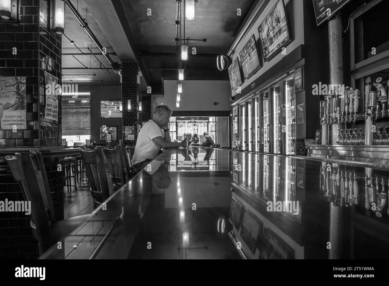 A man having a drink in a Manhattan bar, New York City, America Stock