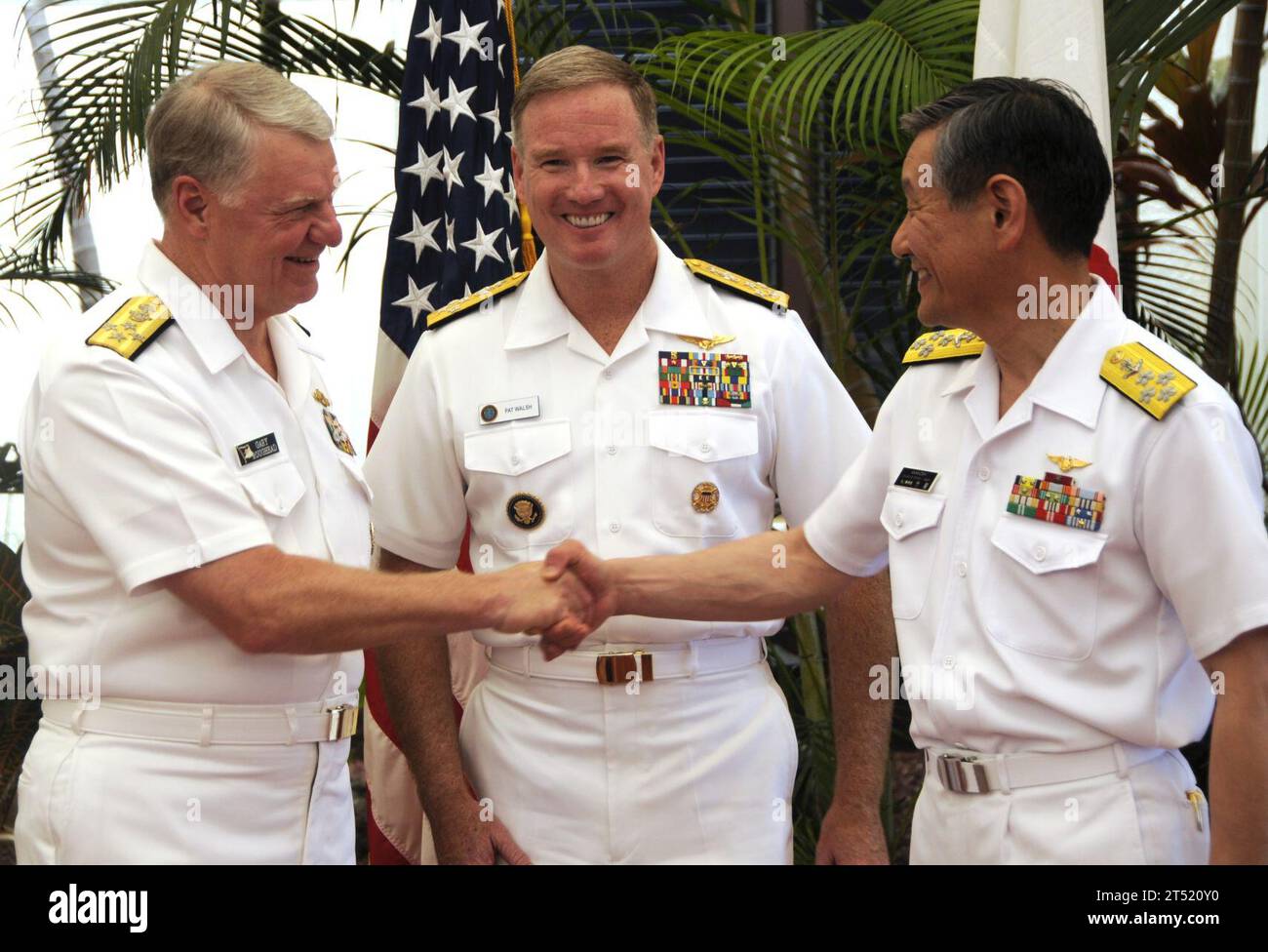 1006097498L-194 PEARL HARBOR (June 9, 2010) Chief of Naval Operations (CNO) Adm. Gary Roughead; left, Adm. Patrick Walsh, commander of U.S. Pacific Fleet; and Adm. Keiji Akahoshi, chief of maritime staff for the Japan Maritime Self-Defense Force, greet during the 2010 U.S.-Japan Junior Officers Symposium.  The Japan Maritime Self-Defense Force Training Squadron arrived at Joint Base Pearl Harbor-Hickam to participate in various professional exchanges and social events with U.S. counterparts. This year marks the 50th anniversary of the U.S. and Japan Treaty of Mutual Cooperation of Security tha Stock Photo