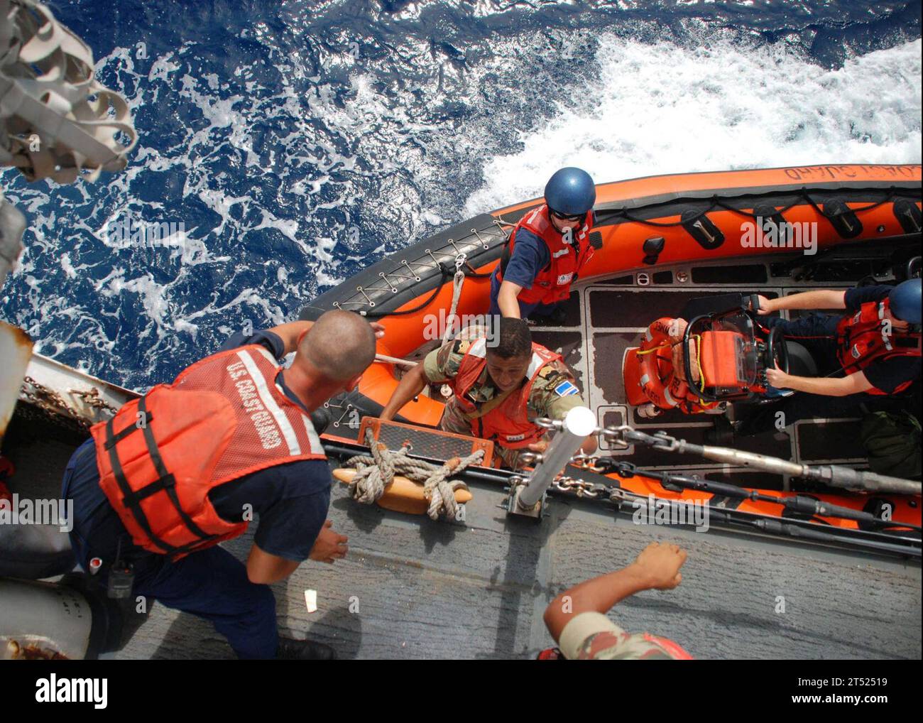 0909016414E-001 ATLANTIC OCEAN (Sept. 1, 2009) Master Chief Victor Delgado of the Cape Verde Coast Guard embarks a small boat from the U.S. Coast Guard Cutter Legare (WMEC 912) during an Africa Partnership Station investigation of a fishing boat off the Cape Verde coast.  Representatives of the Cape Verde Coast Guard and Judiciary Police are teamed with the crew of Legare to patrol Cape Verde's waters. Africa Partnership Station is a Commander, U.S. Naval Forces Europe-Commander, U.S. Naval Forces Africa led initiative to conduct joint maritime law enforcement operations in African waters to i Stock Photo