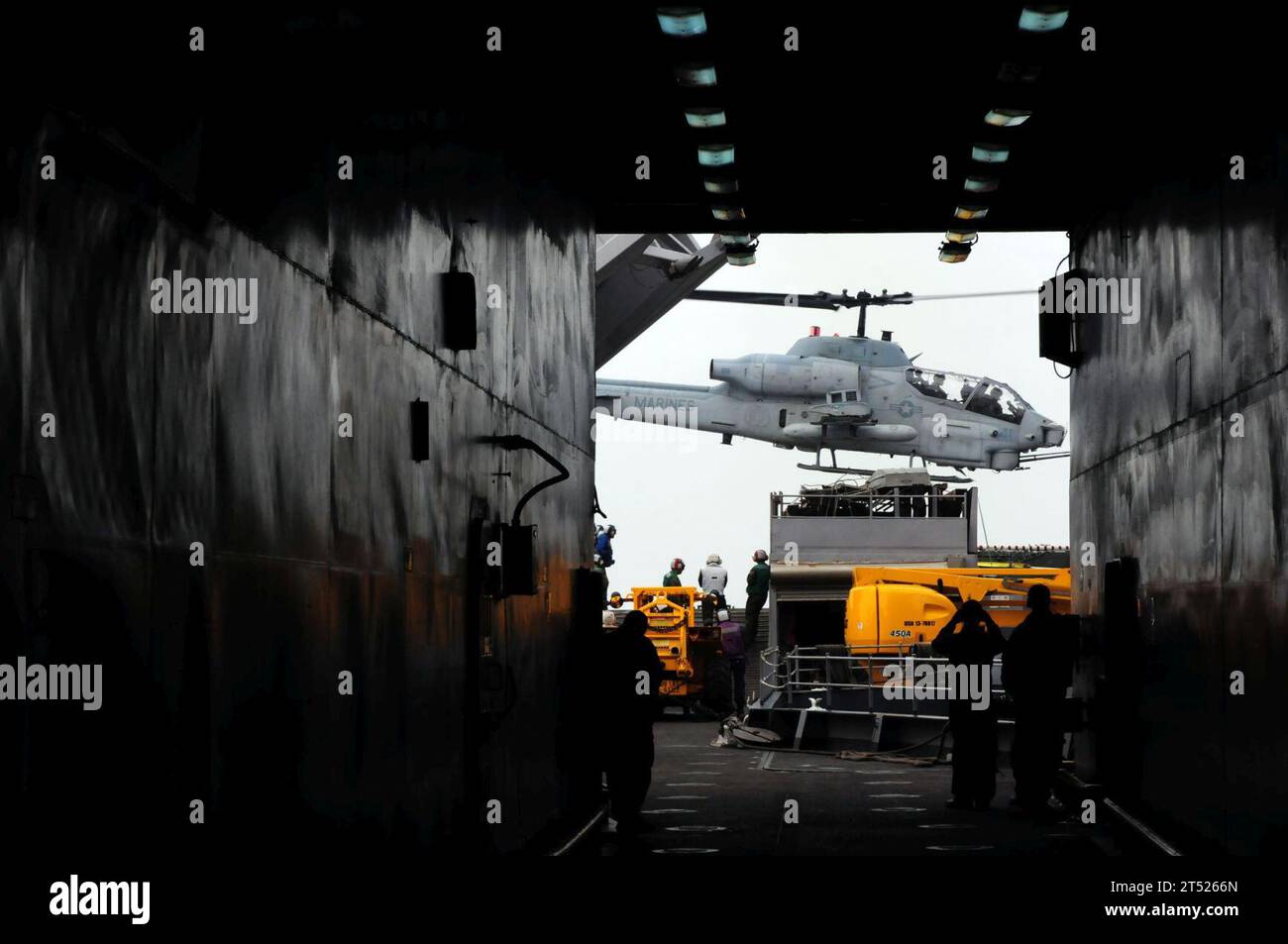 1012153659B-205 PACIFIC OCEAN (Dec. 15, 2010) Sailors aboard the amphibious dock landing ship USS Comstock (LSD 45) watch as an AH-1 Cobra helicopter assigned to the Evil Eyes of Marine Medium Helicopter Squadron (HMM) 163 lifts off from the ship. Comstock, part of the Boxer Amphibious Readiness Group, Combat Logistics Battalion (CLB) 13, and the 13th Marine Expeditionary Unit (13th MEU), are underway off the coast of Southern California participating in certification exercise in preparation for deployment in early 2011. Navy Stock Photo