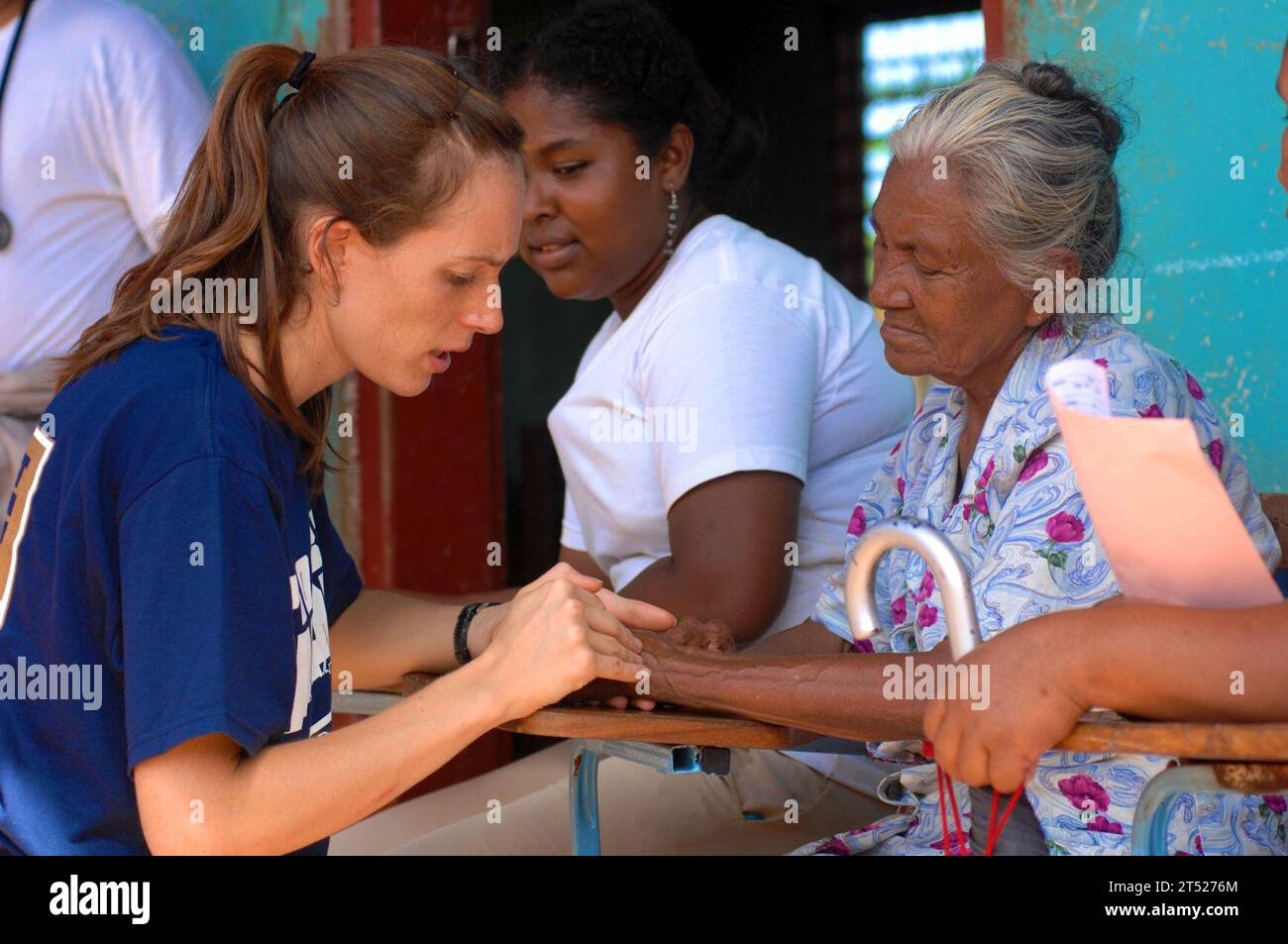 0808157540C-148 PUERTO CABEZAS, Nicaragua (Aug.15, 2008) Project Hope volunteer Sara Joyce, embarked aboard the amphibious assault ship USS Kearsarge (LHD 3), examines the hand of an elderly Nicaraguan woman at a medical clinic at Juan Comenius High School during a Continuing Promise 2008 humanitarian assistance project. Kearsarge is the primary platform for the Caribbean phase of Continuing Promise, an equal-partnership mission involving the United States, Canada, the Netherlands, Brazil, Nicaragua, Panama, Colombia, Dominican Republic, Trinidad and Tobago and Guyana. Navy Stock Photo