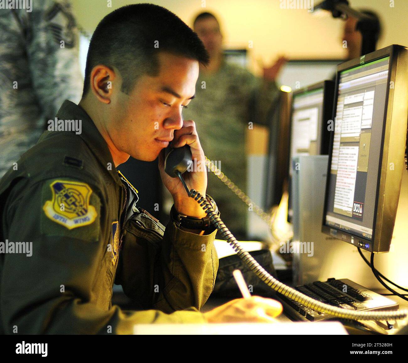 1011097498L-096 PEARL HARBOR (Nov. 9, 2010) Air Force Capt. Jon Ma, assigned to the 15th Wing Command Post, is the air operations representative at the Joint Base Pearl Harbor-Hickam Emergency Operation Center during a chemical, biological, radiological, nuclear and high-yield explosive exercise. Navy Stock Photo