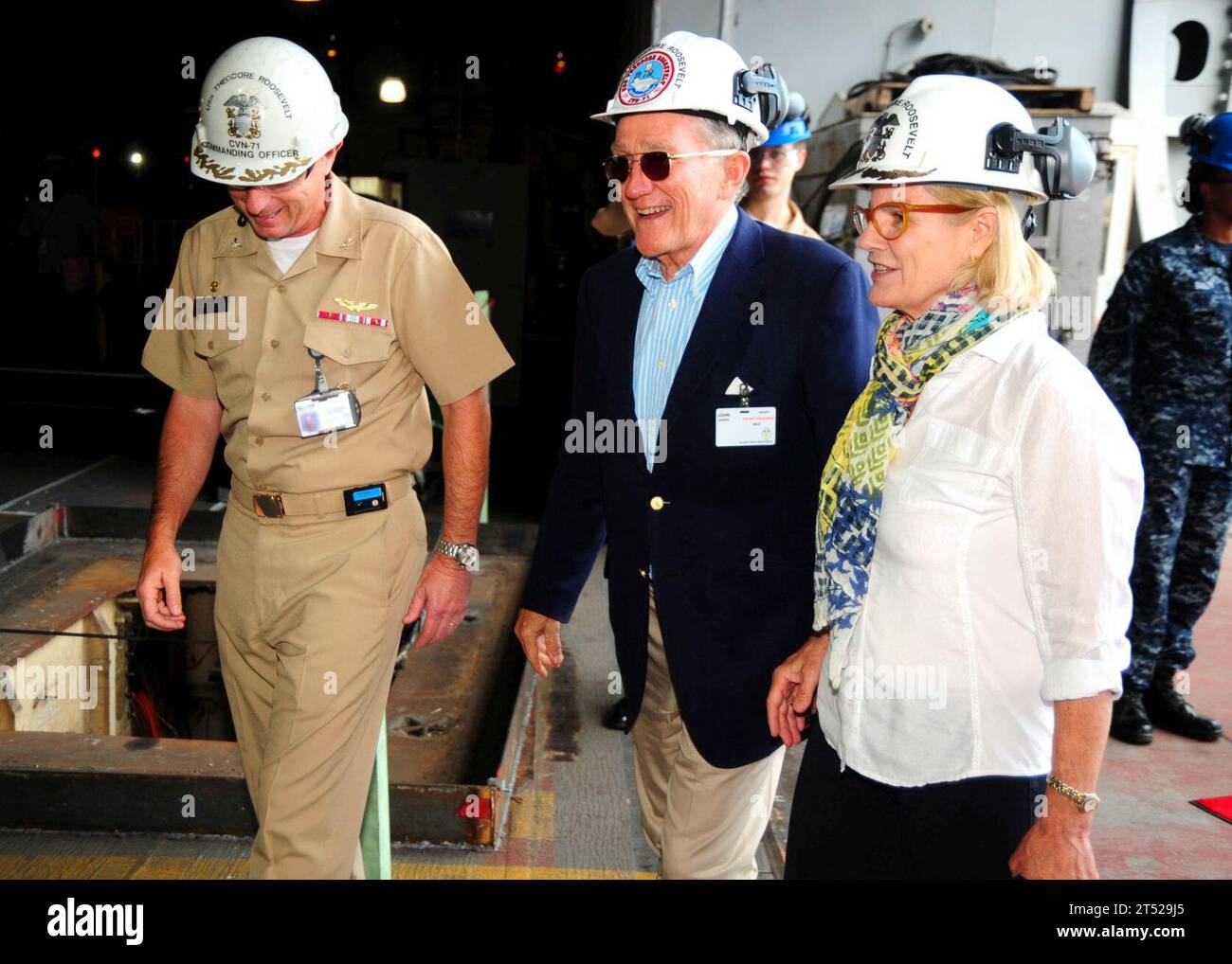 110621NB178-022 NEWPORT NEWS, Va. (June 21, 2011) Capt. Bill Hart, left, commanding officer of the aircraft carrier USS Theodore Roosevelt (CVN 71), gives former Secretary of the Navy John F. Lehman and his wife, Barbara, a tour the ship. Theodore Roosevelt is undergoing a refueling complex overhaul at Newport News Shipbuilding. Barbara Lehman is the ship's sponsor. Hart's identification badge has been digitally altered for security reasons. Navy Stock Photo