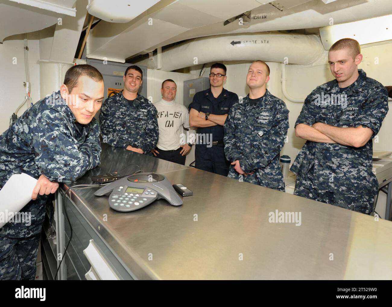 1012297095C-005 ARABIAN SEA (Dec. 29. 2010) Sailors aboard the aircraft carrier USS Abraham Lincoln (CVN 72) speak with Boston Bruins goalie Tim Thomas during a phone call from the hockey player to the aircraft carrier. ThomasХ phone call is the latest in a series of recent calls from prominent Boston sports figures to Abraham Lincoln sports fans. The Abraham Lincoln Carrier Strike Group is deployed in the U.S. 5th Fleet Area of Responsibility conducting maritime security operations and theater security cooperation efforts. Navy Stock Photo