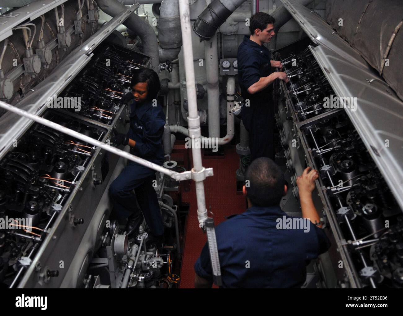 110302DM338-102 PACIFIC OCEAN (March 2, 2011) Sailors assigned to the aircraft carrier USS Ronald Reagan (CVN 76) open the cylinder head covers on the aft emergency diesel generators in preparation for daily maintenance. The Ronald Reagan Carrier Strike Group is underway continuing training before deploying to the western Pacific Ocean and U.S. Central Command area of responsibility. Navy Stock Photo