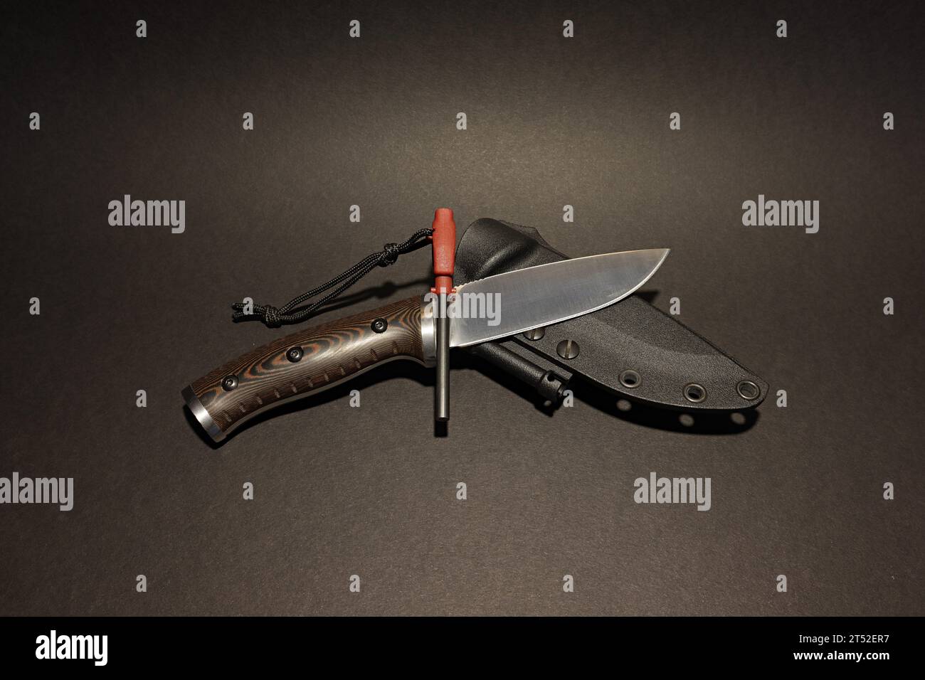 A multifunctional survival knife a micarta handle, a fire starter and with the sheath Stock