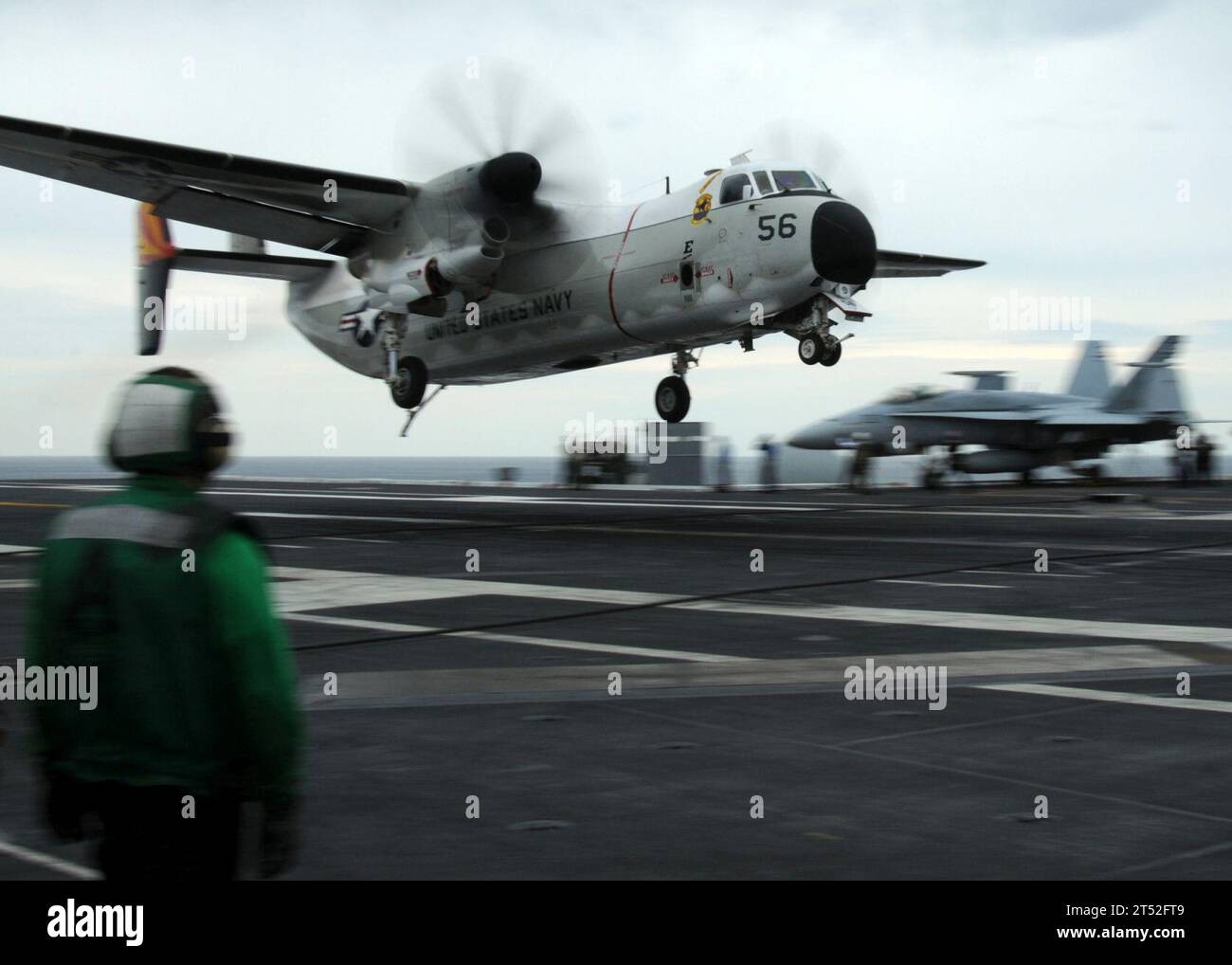 1004217908T-664 ATLANTIC OCEAN (April 21, 2010) A sailor aboard the aircraft carrier USS George H.W. Bush (CVN 77) observes the landing of a C-2A Greyhound, assigned to Fleet Logistics Support Squadron (VRC) 40. The George H.W. Bush is conducting carrier qualifications in the Atlantic Ocean. Navy Stock Photo