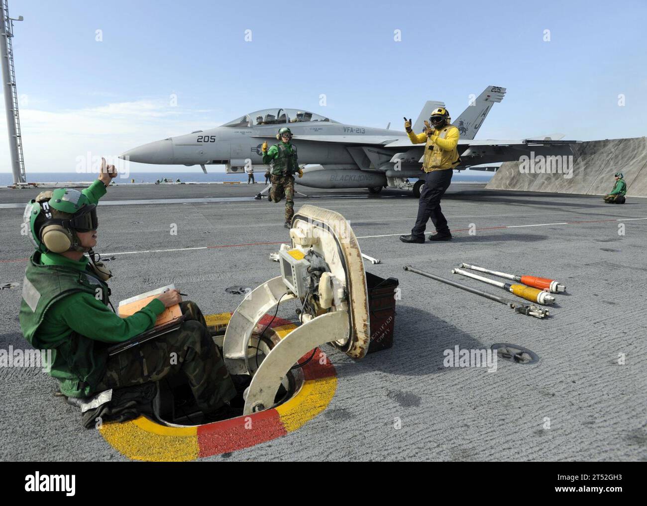 0809097241L-004 ATLANTIC OCEAN (Sept. 9, 2008) Flight deck personnel aboard the aircraft carrier USS Theodore Roosevelt (CVN 71) prepare to launch an F/A-18F Super Hornet strike fighter assigned to the ТBlacklionsУ of Strike Fighter Squadron (VFA) 213. Roosevelt is deployed as the lead ship of the Theodore Roosevelt Carrier Strike Group supporting maritime security operations in the U.S. 5th and 6th Fleet areas of responsibility. Navy Stock Photo
