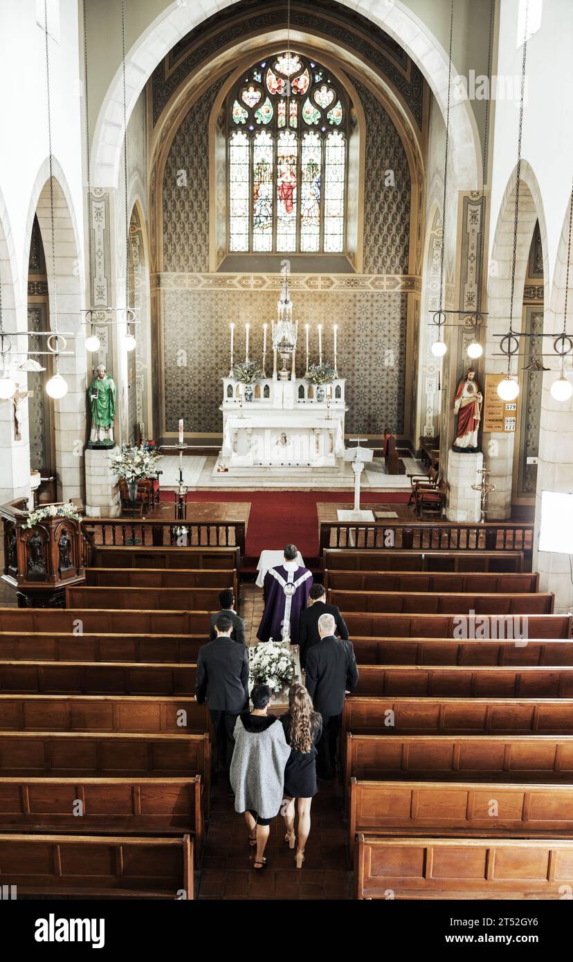 Funeral, church and people walking together to carry a coffin after a