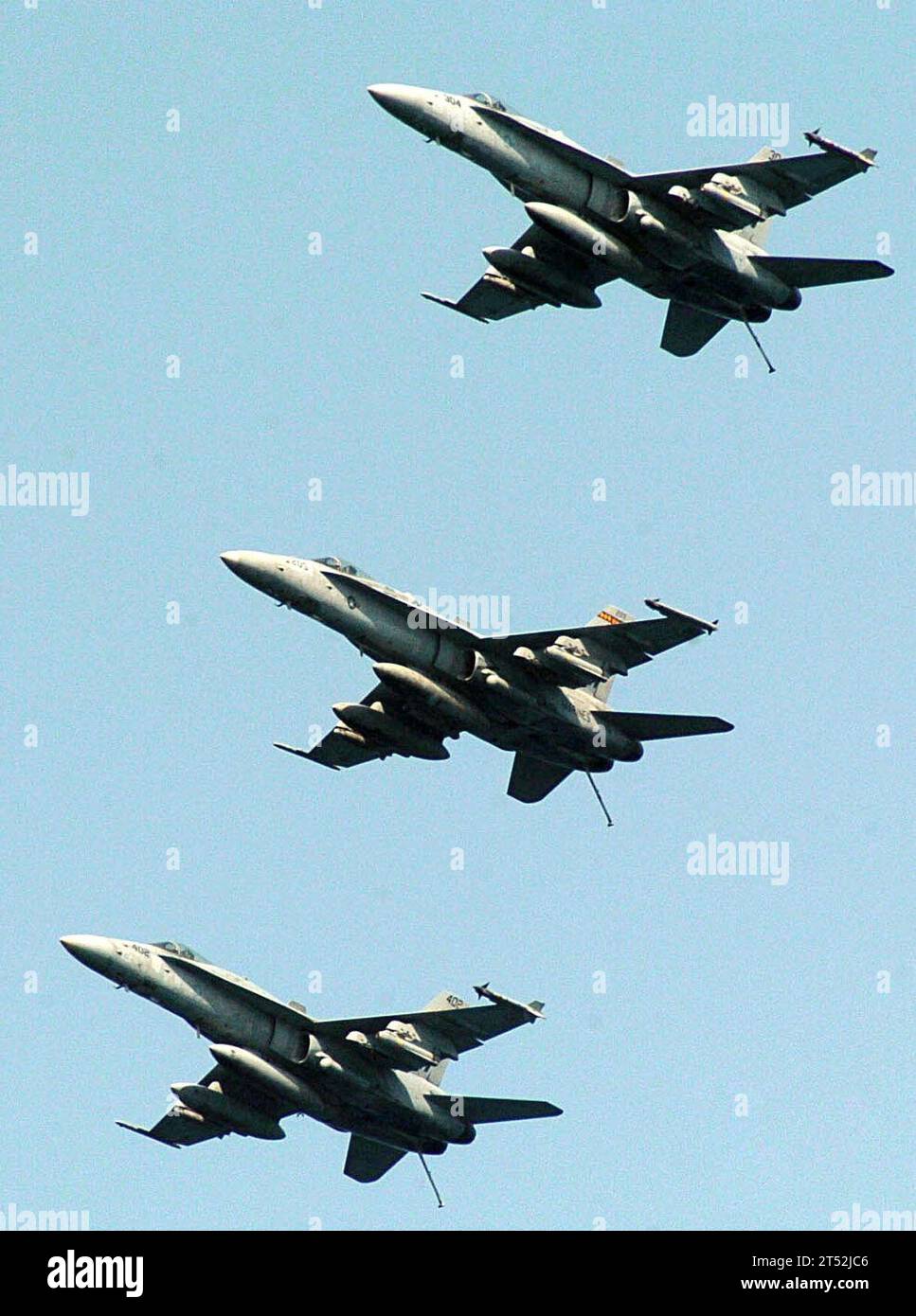 0707043038W-196  PERSIAN GULF (July 4, 2007) - Three F/A-18C Hornets from three different squadrons assigned to Carrier Air Wing 9 fly in formation above Nimitz-class aircraft carrier USS John C. Stennis (CVN 74). Stennis and Carrier Air Wing 9 are on a scheduled deployment in support of the global war on terrorism and maritime operations. Maritime operations help set the conditions for security and stability in the maritime environment, as well as complement counter-terrorism and security efforts of regional nations. U.S. Navy Stock Photo