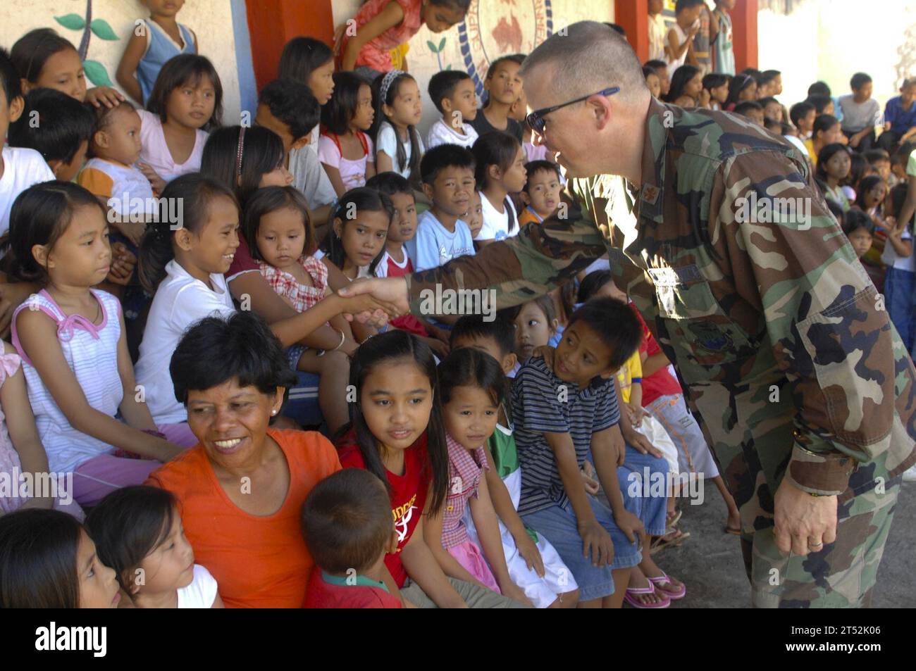 0712157286M-010 ZAMBOANGA CITY, Philippines (Dec. 15, 2007) U.S. Air Force Chaplin, Maj. Philip G. Houser meets with the children at MEIN College. Sailors, Airmen and Soldiers assigned to Joint Special Operations Task Force-Philippines (JSOTF-P) assisted MEIN College, INC. and the Kiwanis Club of METRO Zamboanga in handing out presents for the holidays at the as part of their annual community outreach program. U.S. Navy Stock Photo