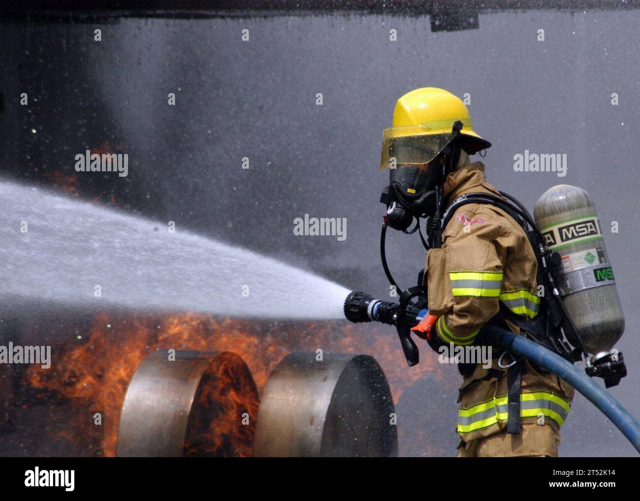 0807305277R-003  ATSUGI, Japan (July 30, 2008) A Commander, Naval Forces Japan firefighter douses a fire on a dummy aircraft during the annual off-station mishap drill at Naval Support Facility Kamiseya. Emergency response and rescue teams were tasked with putting out a simulated fire, and rescuing two personnel from a plane crash scene. U.S. Navy Stock Photo