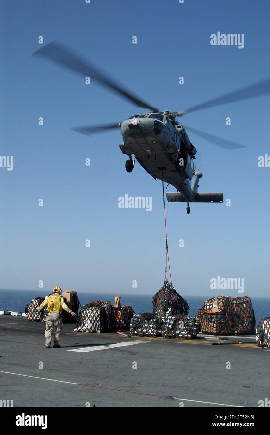 0710317955L-073 INDIAN OCEAN (Oct. 31, 2007) - An MH-60S Seahawk assigned to Helicopter Combat Sea Squadron (HSC) 26, drops pallets of supplies onto the flight deck of amphibious assault ship USS Kearsarge (LHD 3) during a vertical replenishment. Kearsarge is on deployment conducting maritime operations. U.S. Navy Stock Photo