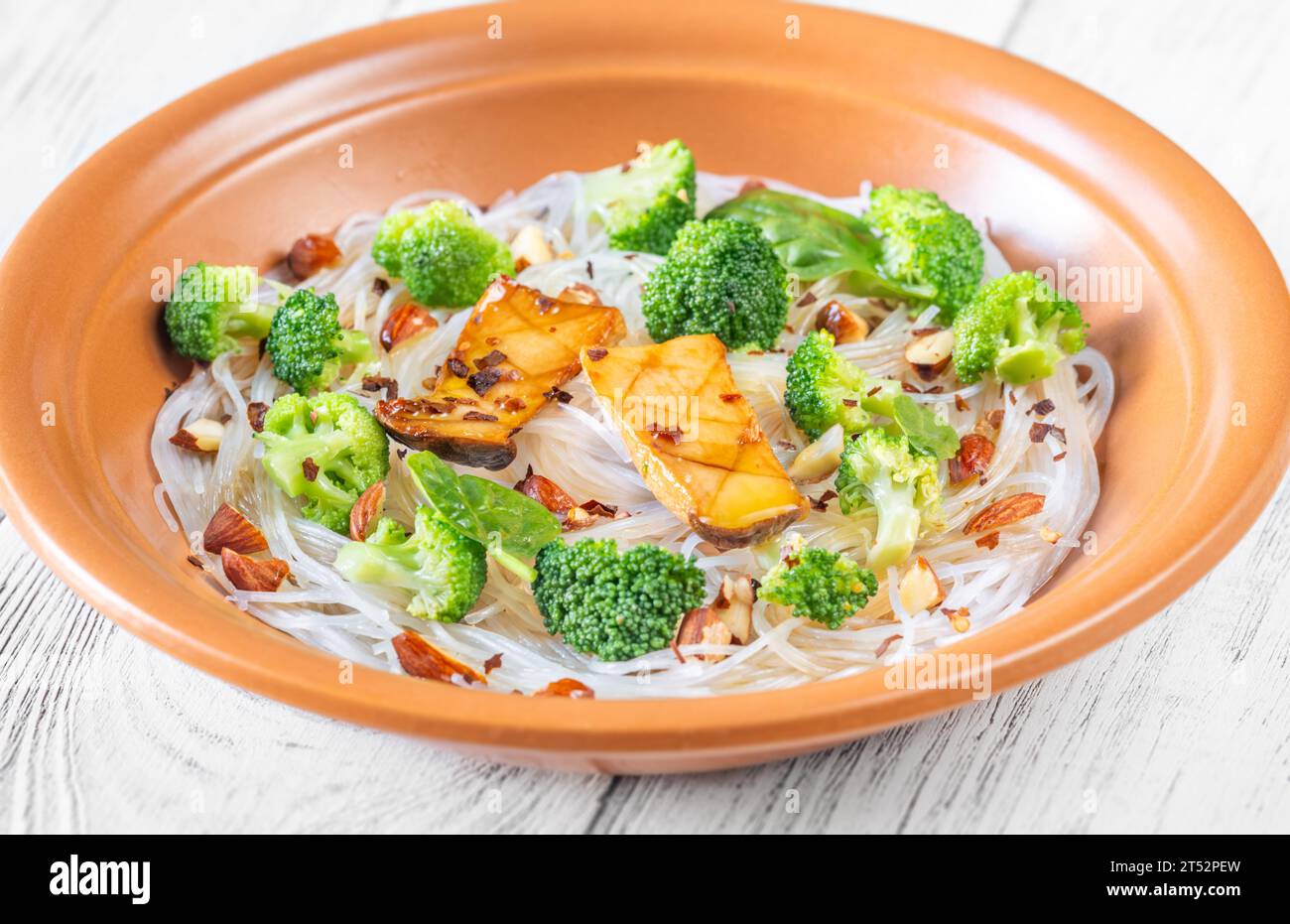 Cellophane noodles with broccoli, almonds and mushrooms Stock Photo