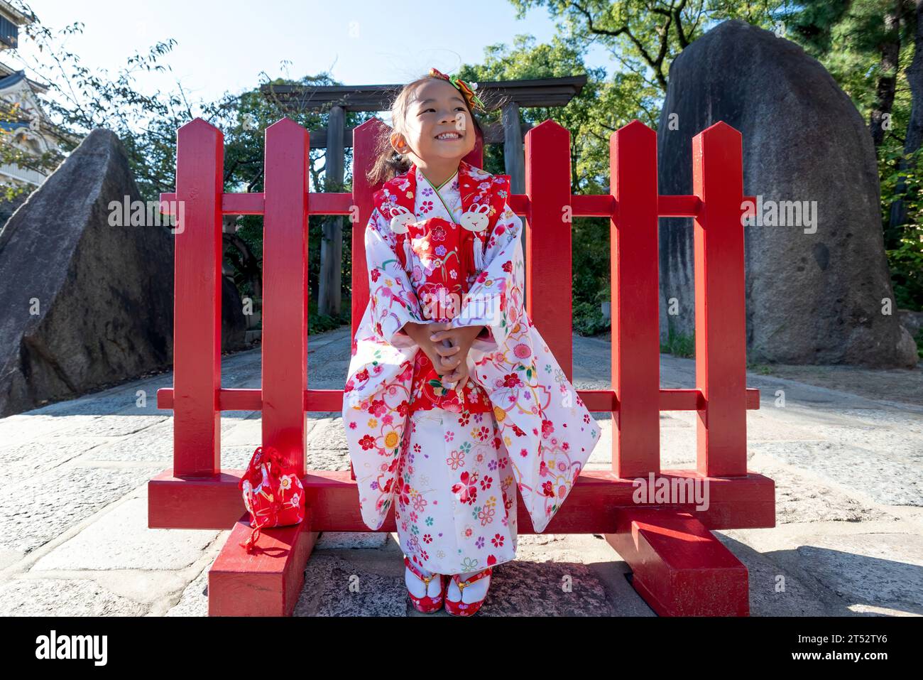 A happy toddler girl wearing red Japanese kimono Stock Photo