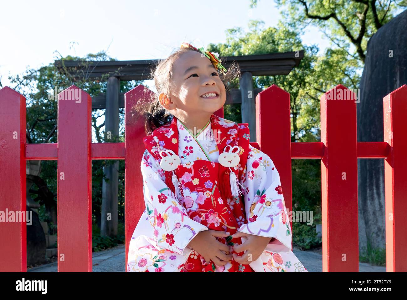 A happy toddler girl wearing red Japanese kimono Stock Photo
