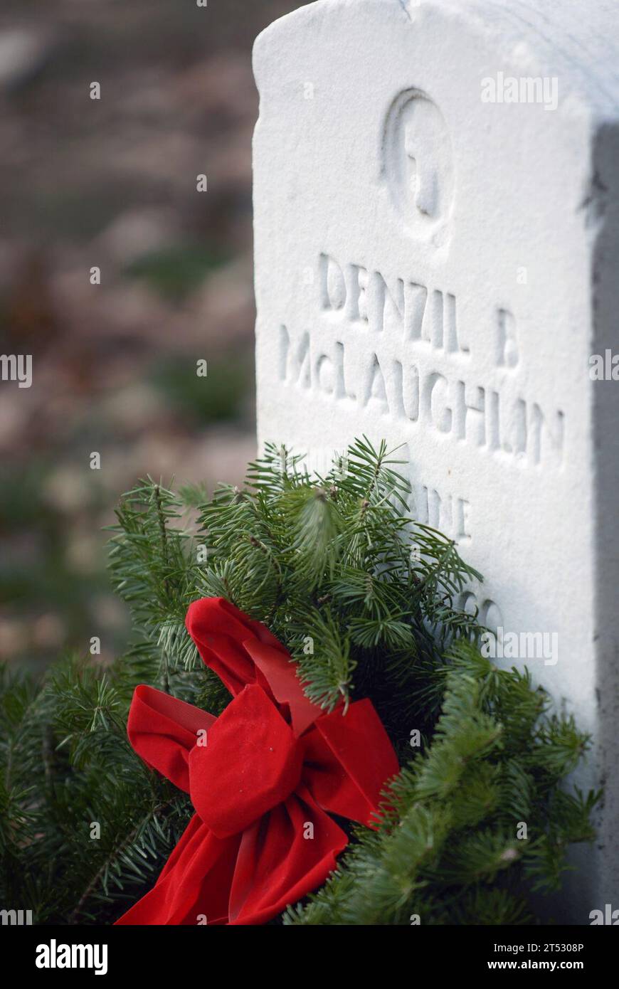 0712150502M-038 ARLINGTON, Va. (Dec. 12, 2007) The final resting place of Private Denzil McLaughlin, a World War I veteran, receives a holiday wreath during the annual Wreaths Across America wreath-laying ceremony. Despite icy winds, more than 1000 volunteers arrived at Arlington National Cemetery to place 10,000 holiday wreaths on the graves in section 33. This year marked the first year that simultaneous ceremonies were conducted in veteran cemeteries and monuments worldwide. U.S. Navy Stock Photo