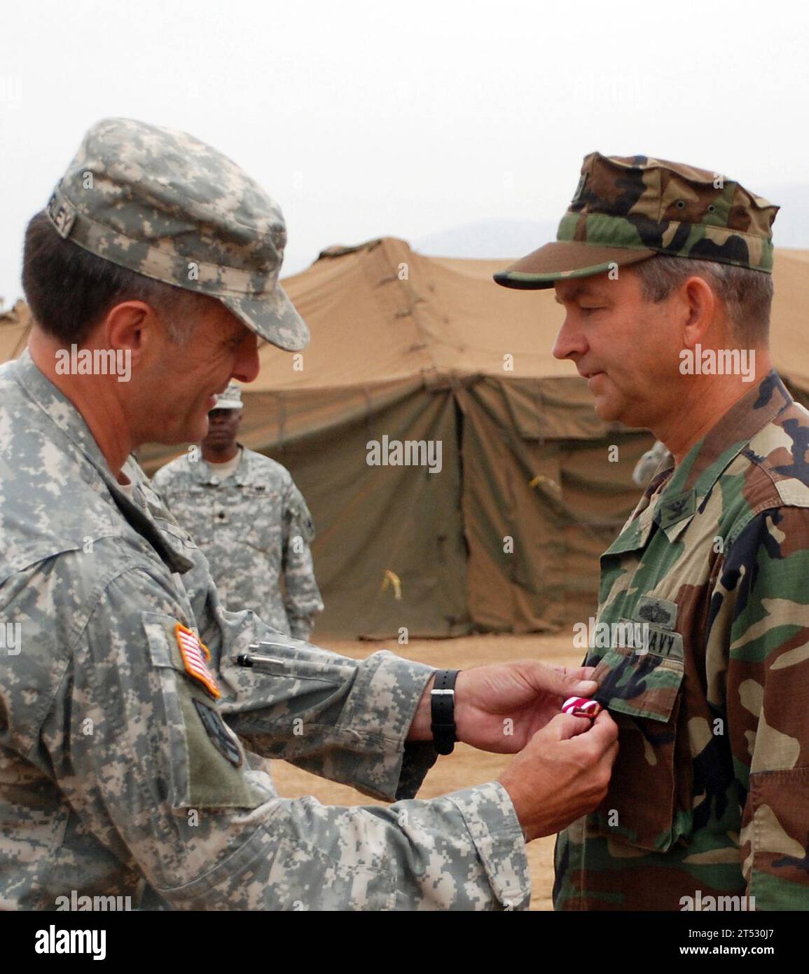 0808014973M-052 CAMP PENDLETON, Calif. (August 1, 2008) Brig. Gen. Mark MacCorley, deputy commander of Joint Task Force (JTF) 8, awards the Meritorious Service Medal to Capt. Thomas Weatherald, commander of Joint Logistics Over-The-Shore (JLOTS) 2008. JLOTS 2008 is an engineering, logistical training exercise between Army and Navy units under a joint force commander as a means to load and unload ships without the benefit of deep draft-capable, fixed port facilities. Stock Photo
