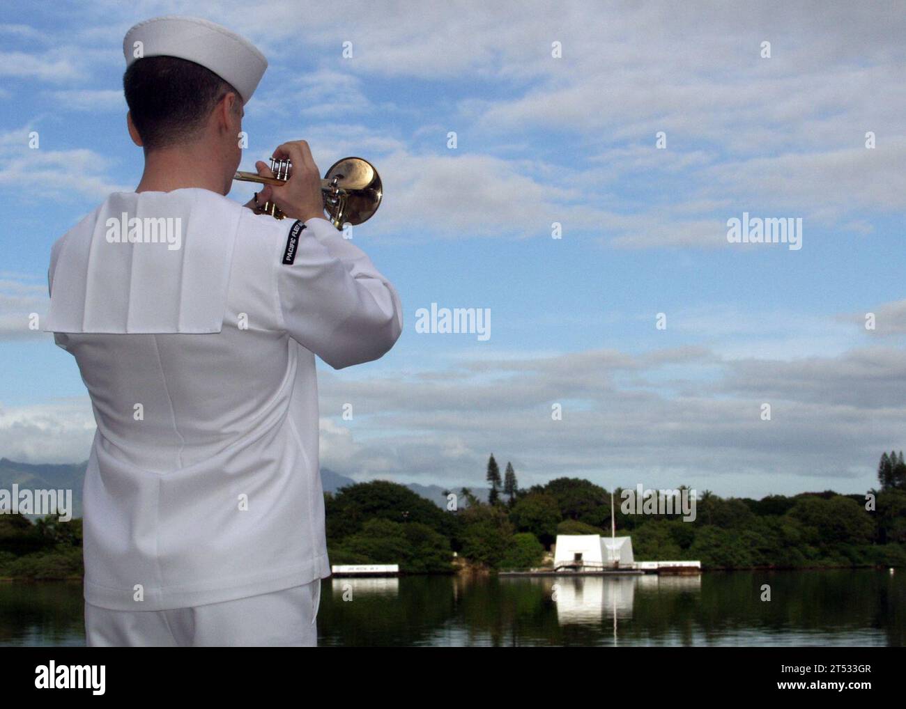 0812070879R-004  PEARL HARBOR, Hawaii (Dec. 7, 2008) A Sailor from the U.S. Pacific Fleet Band plays taps during a joint U.S. Navy/National Park Service ceremony commemorating the 67th anniversary of the attack on Pearl Harbor. The theme of this yearХs historic commemoration, ТPacific War Memories: The Heroic Response to Pearl Harbor,У emphasized the brave efforts of those who fought at sea, on land, and in the air, to turn the tide in the Pacific. More than 2,000 distinguished guests and the general public joined service members, Pearl Harbor survivors and their families and friends for the a Stock Photo