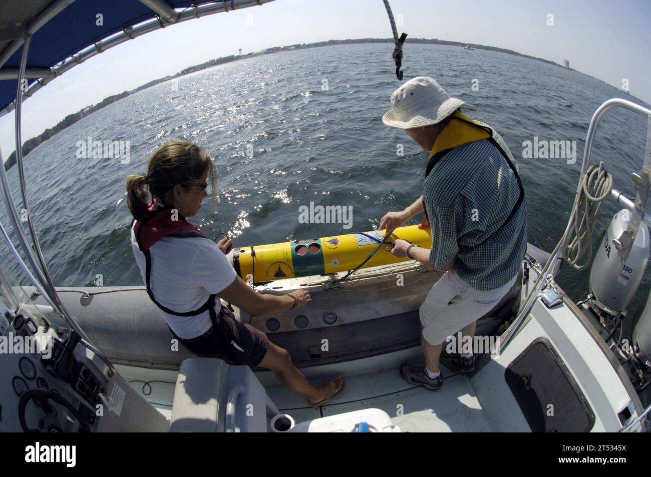 0706117676W-166 PANAMA CITY BEACH, Fla. (June 11, 2007) - Amy Kukulya and Tom Austin, both from the Woods Hole Oceanographic Institution, prepare to launch a Remote Environmental Monitoring Units (REMUS) during Autonomous Underwater Vehicle (AUV) Fest 2007, hosted by the Naval Surface Warfare Center Panama City and sponsored by the Office of Naval Research. Capable of performing rapid environmental surveys, REMUS also functions as an underwater mine reconnaissance device for the NavyХs mine countermeasures program. AUV Fest is the largest in-water demonstration of unmanned underwater, surface, Stock Photo