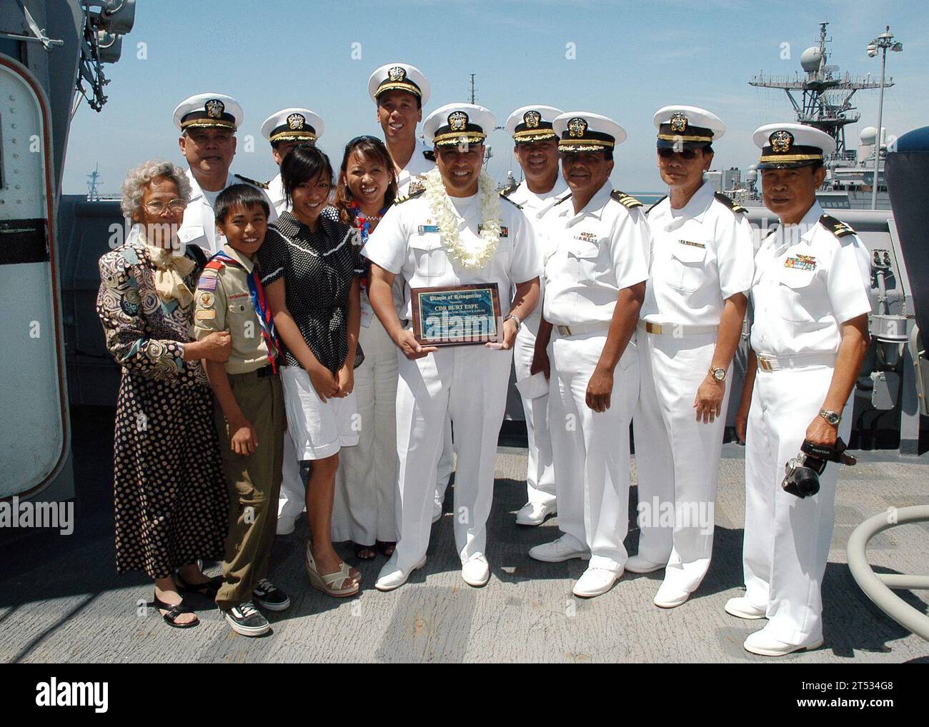 0705313970R-076 SAN DIEGO (May 31, 2007) Р Dock landing ship USS Comstock (LSD 45) Commanding Officer, Cmdr. Burt L. Espe and his family receive an outstanding achievement award by retired Cmdr. Gil Gonzales, president of the Filipino American Military Officer Association. Espe earned the award for his reconstruction efforts with the Philippine Armed Forces. Comstock returned home from a near nine-month deployment in support of the global war on terrorism. U.S. Navy Stock Photo
