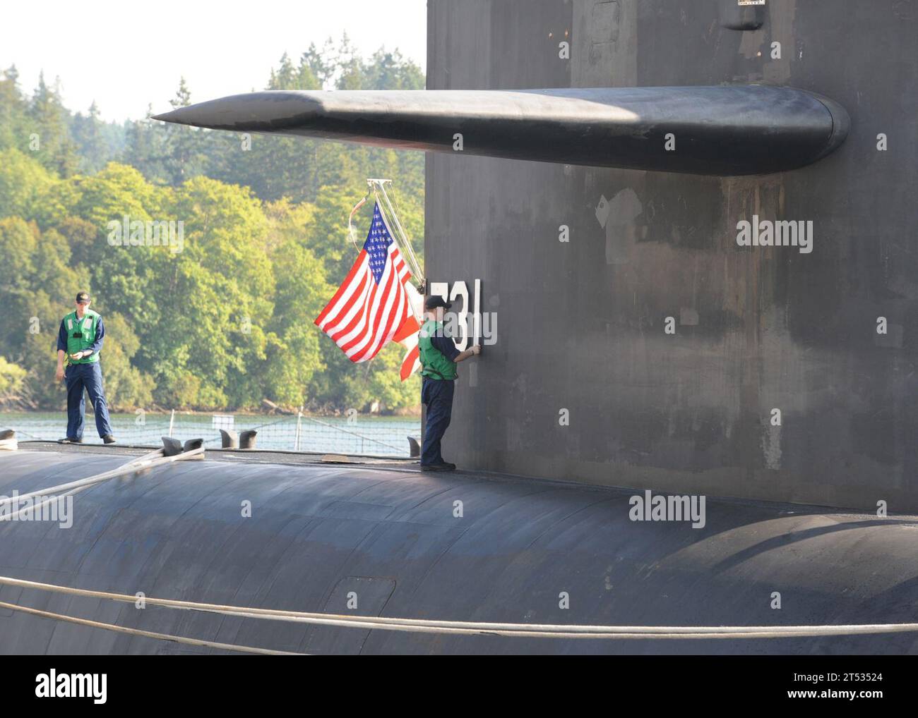 0907311325N-005 BANGOR, Wash. (July 31, 2009) A Sailor assigned to the Ohio class ballistic missile submarine USS Alabama (SSBN 731) places the hull number on the sail of Alabama after tying up at the Delta Pier at Naval Base Kitsap. (U.S. Navy Stock Photo