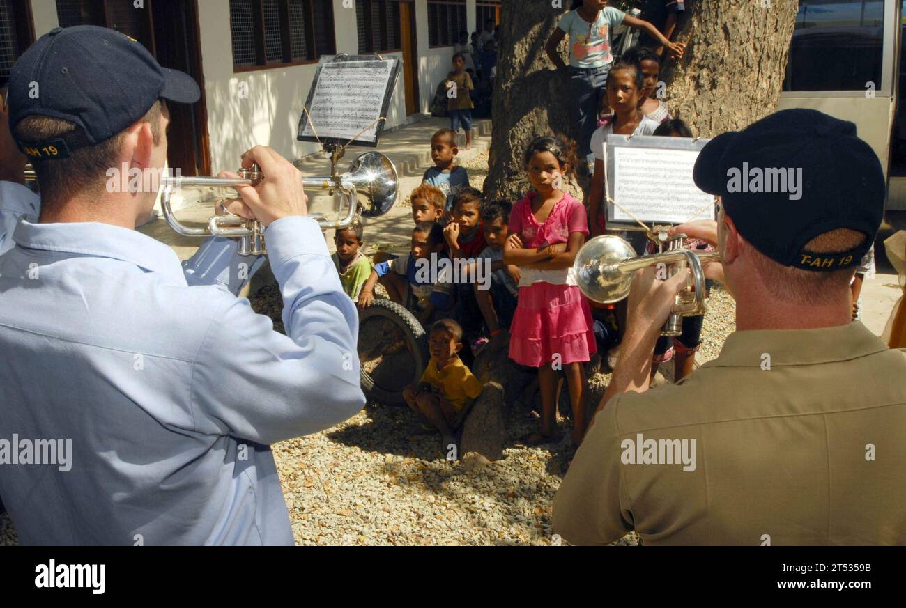 0807245911S-094 DILI, East Timor (July 24, 2008) Members of the U.S. Navy Pacific Fleet Band, embarked aboard the Military Sealift Command hospital ship USNS Mercy (T-AH 19) perform for Timorese children during a ribbon-cutting ceremony during a Pacific Partnership engineering civic action program at Bario Pite Elementary school. The Pacific Partnership mission focuses on establishing friendships with partner and host nations through humanitarian and civic assistance. U.S. Navy Stock Photo