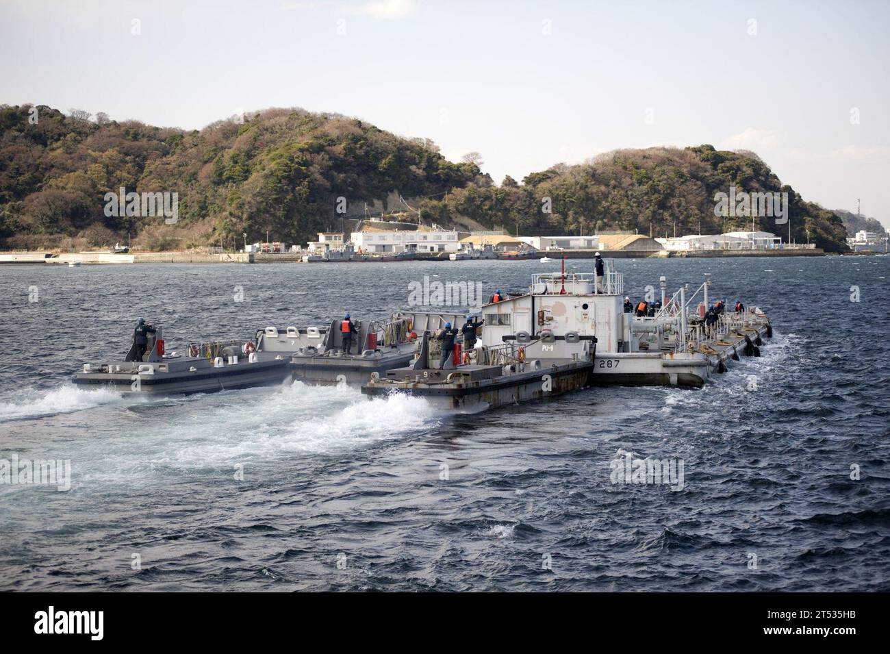 110326UZ446-088 YOKOSUKA, Japan (March 26, 2011) U.S. Navy Barge YON-287, filled with 851,000 liters (225,000 gallons) of fresh water, departs Fleet Activities Yokosuka to support cooling efforts at the Fukushima Daiichi nuclear power plant. YON-287 is the second of two barges supplied by the U.S. Navy to the government of Japan to aid in the cooling efforts. The two barges supplied a total of 1.89 million liters (500,000 gallons) of fresh water. Stock Photo